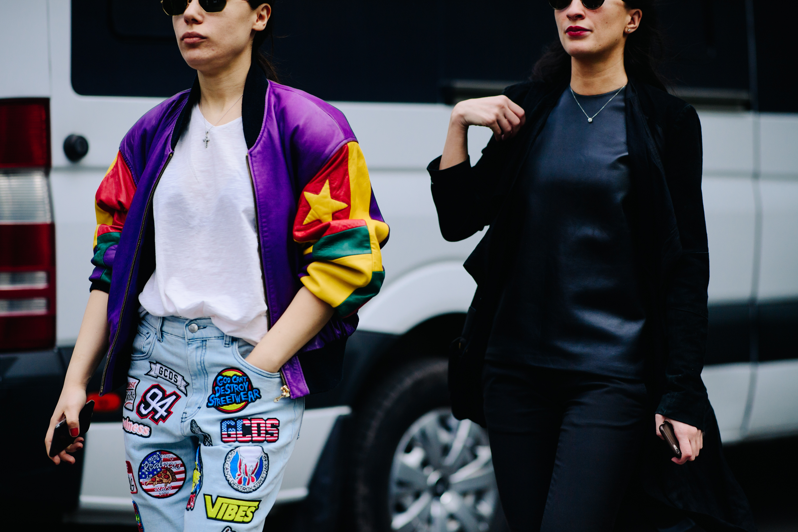 Two women wearing contrasting outfits
