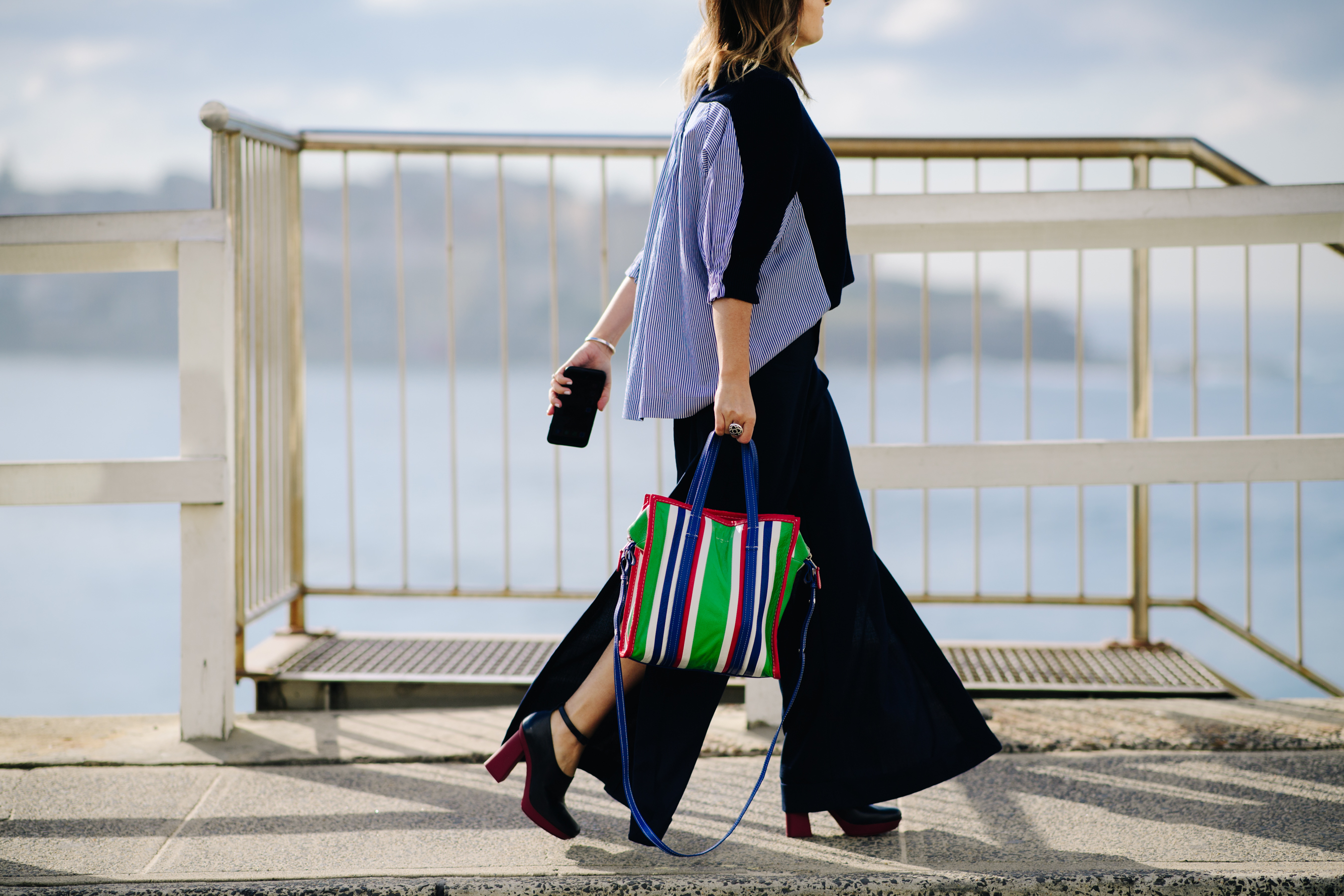Woman carrying a striped bag