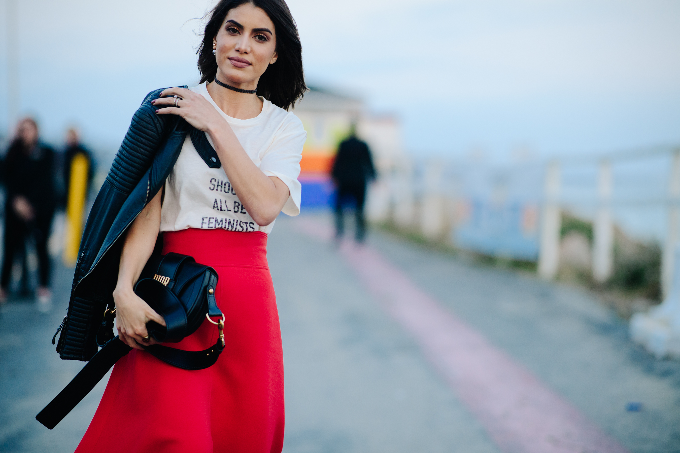 Woman carrying a Dior clutch