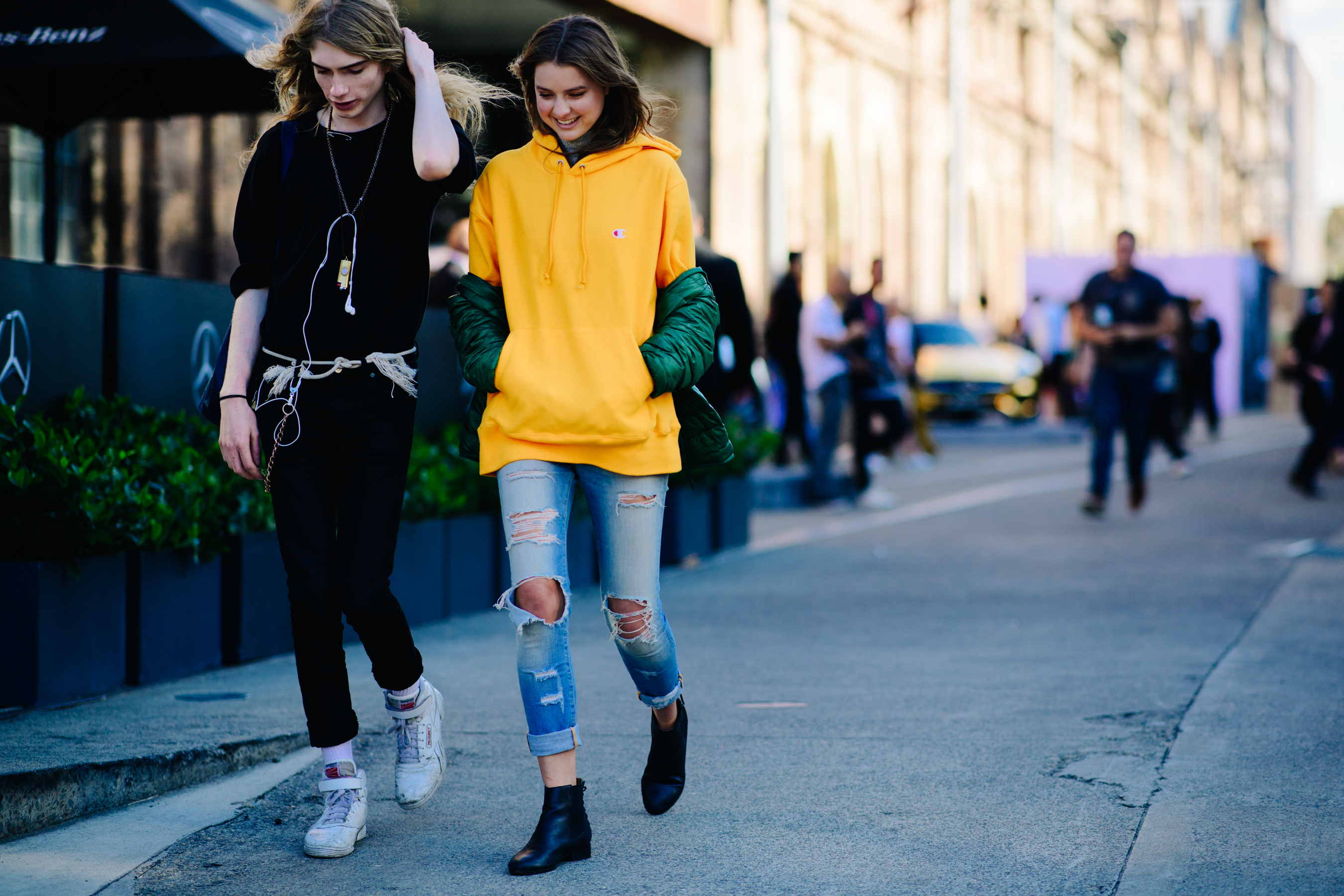 Two models wearing Reebok and Champion
