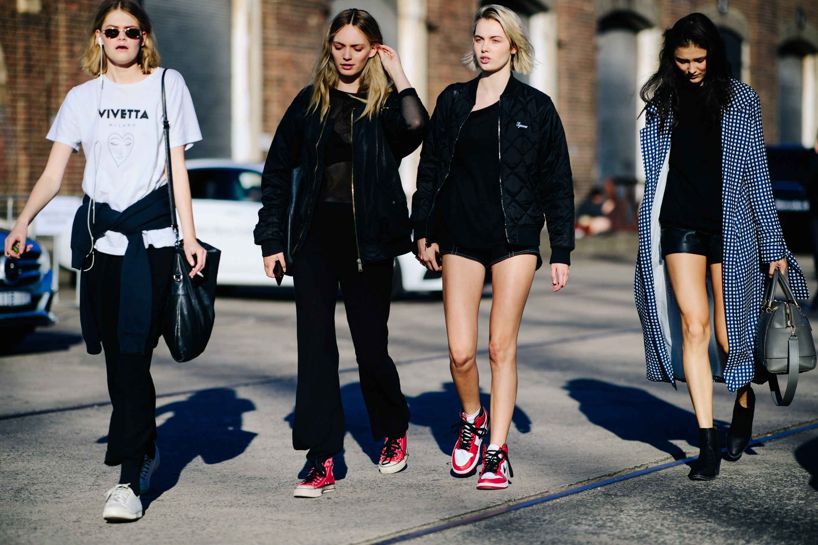 Four models wearing Converse and Nike