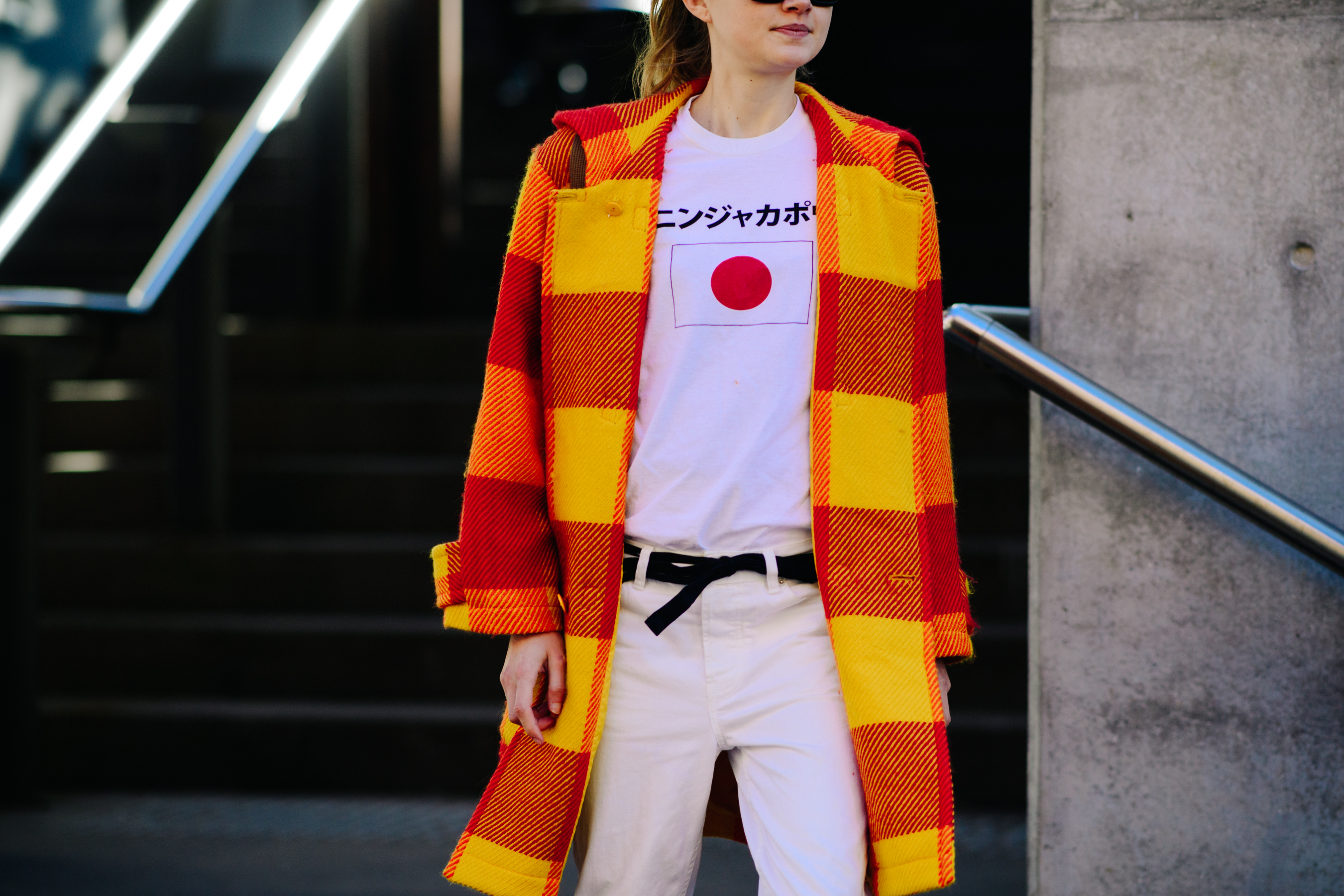 Girl wearing a plaid orange coat