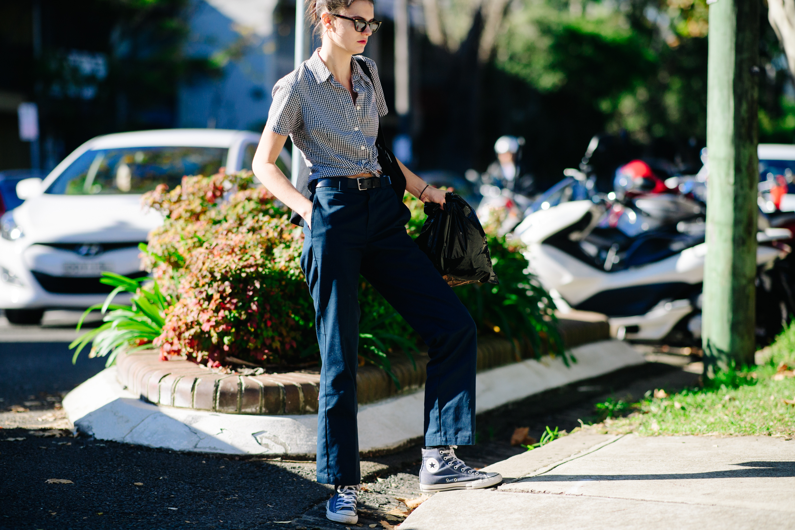 Model wearing navy blue trousers