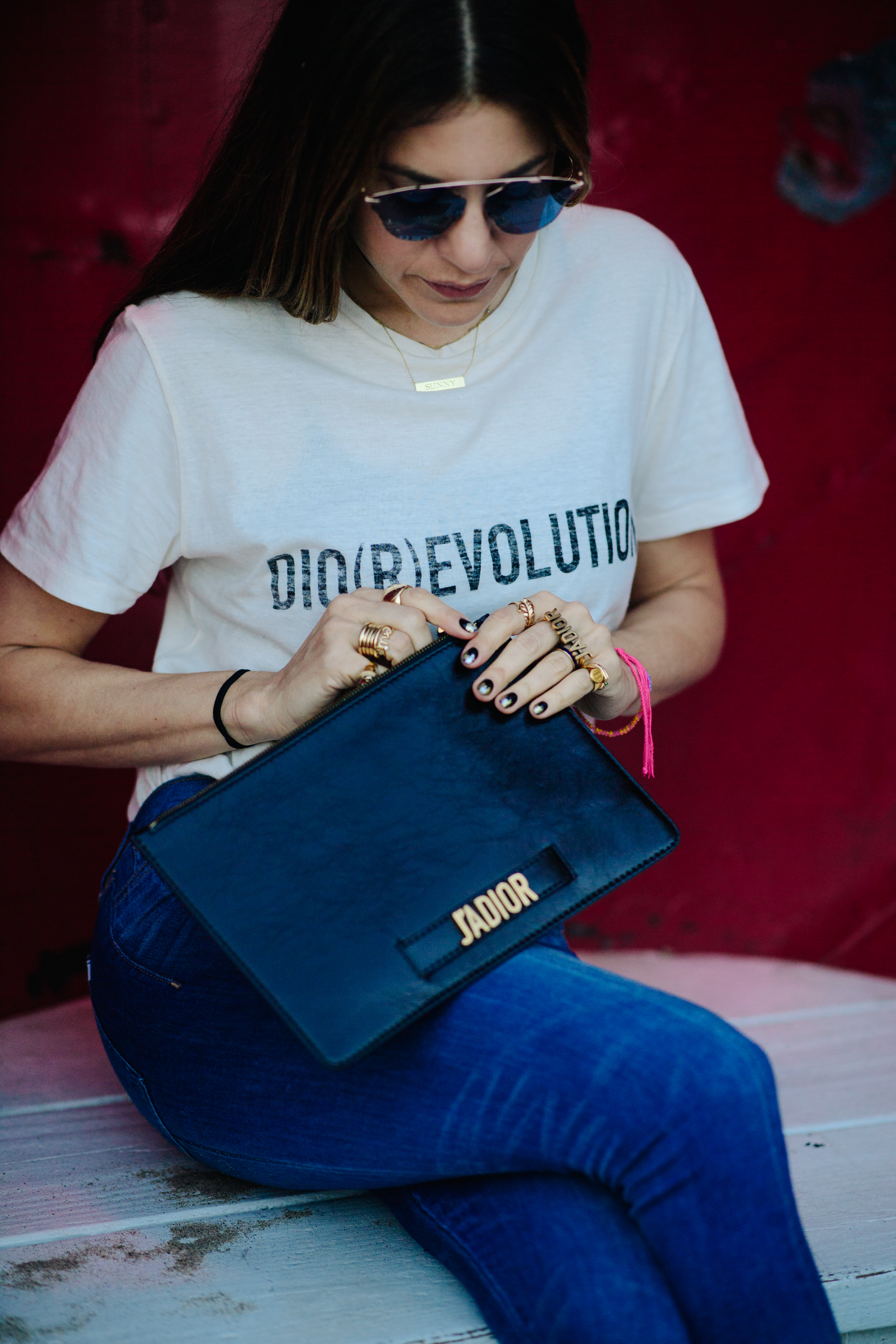 Woman carrying a black leather clutch