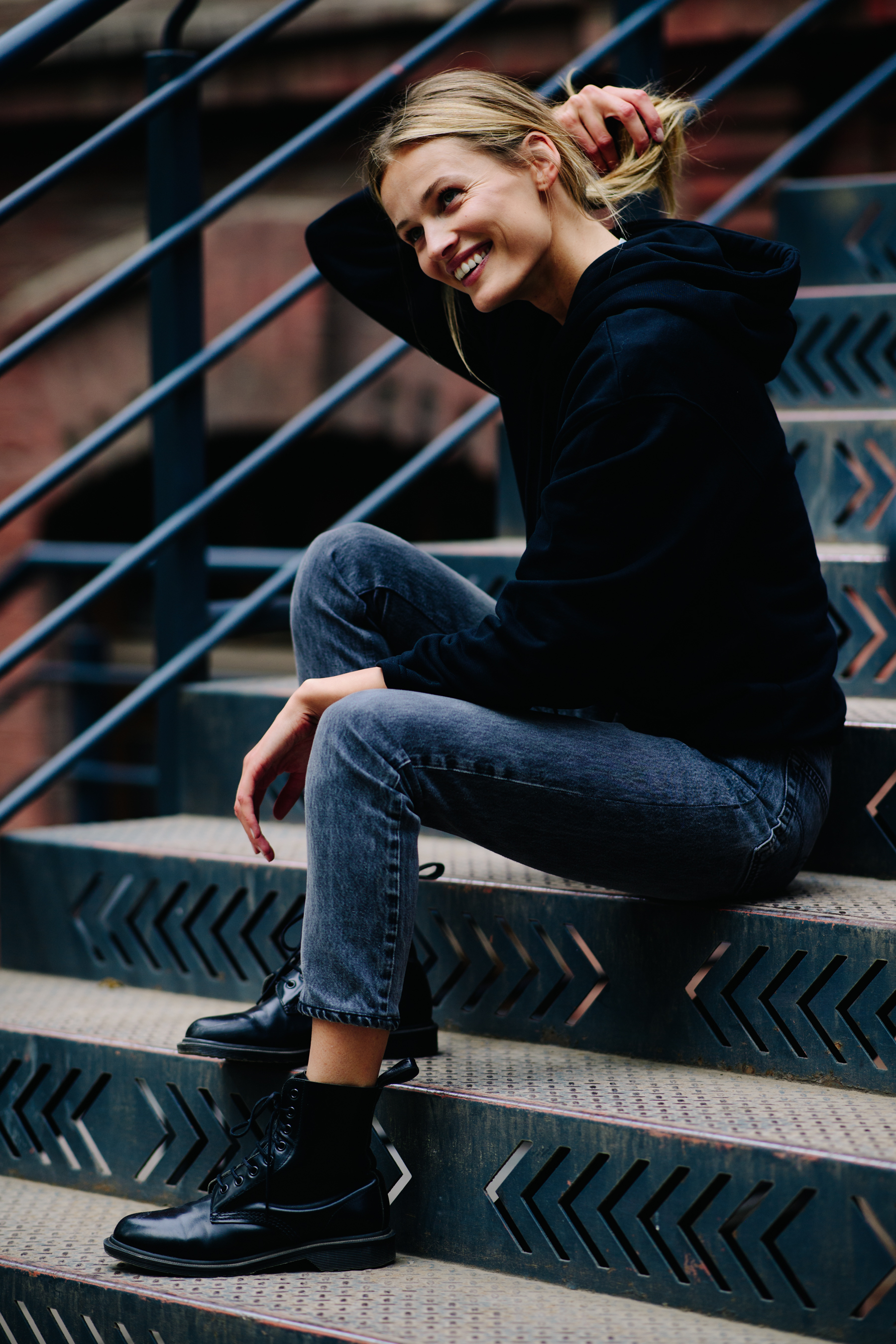 Blonde girl sitting on industrial stairs