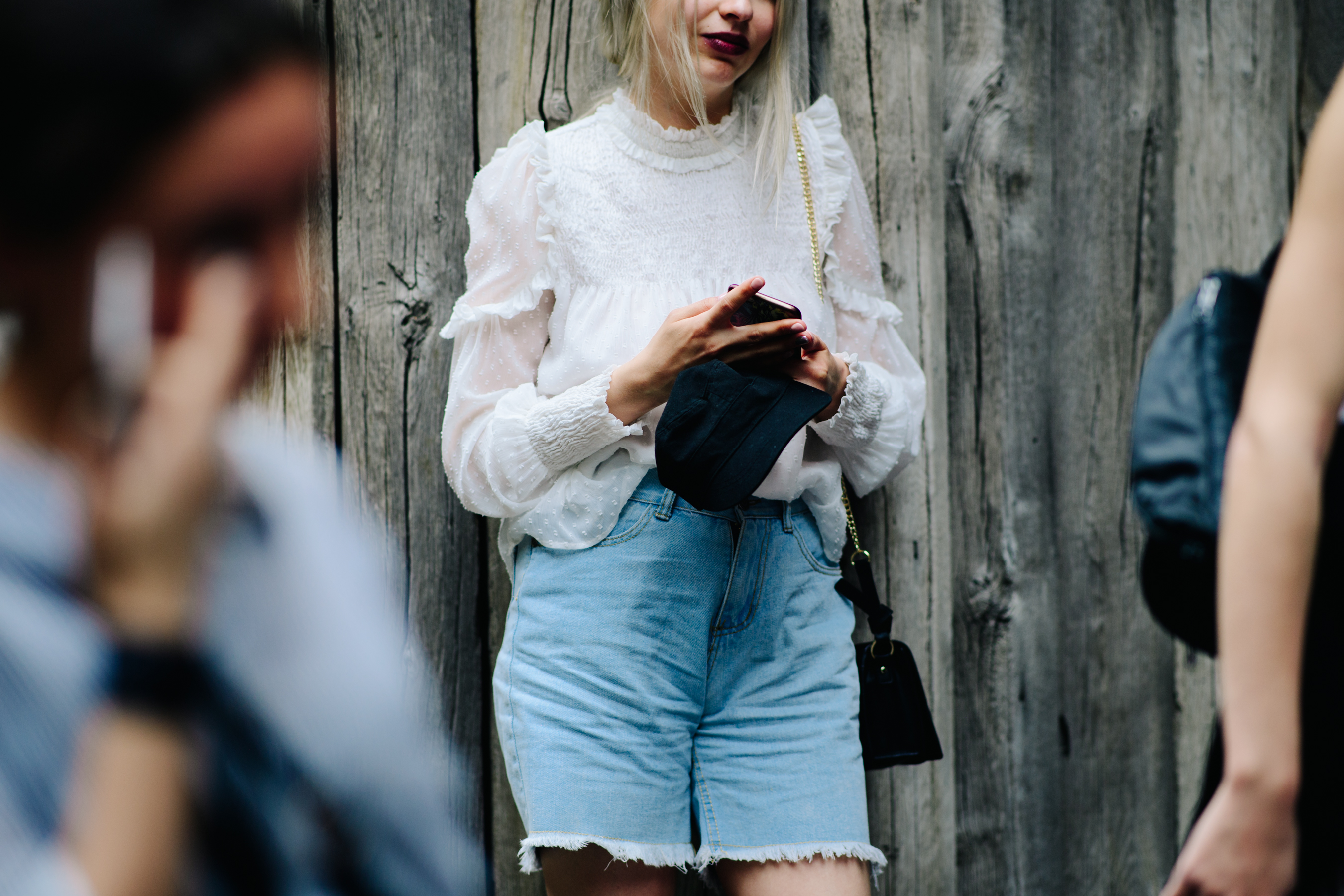 Girl wearing ripped denim shorts