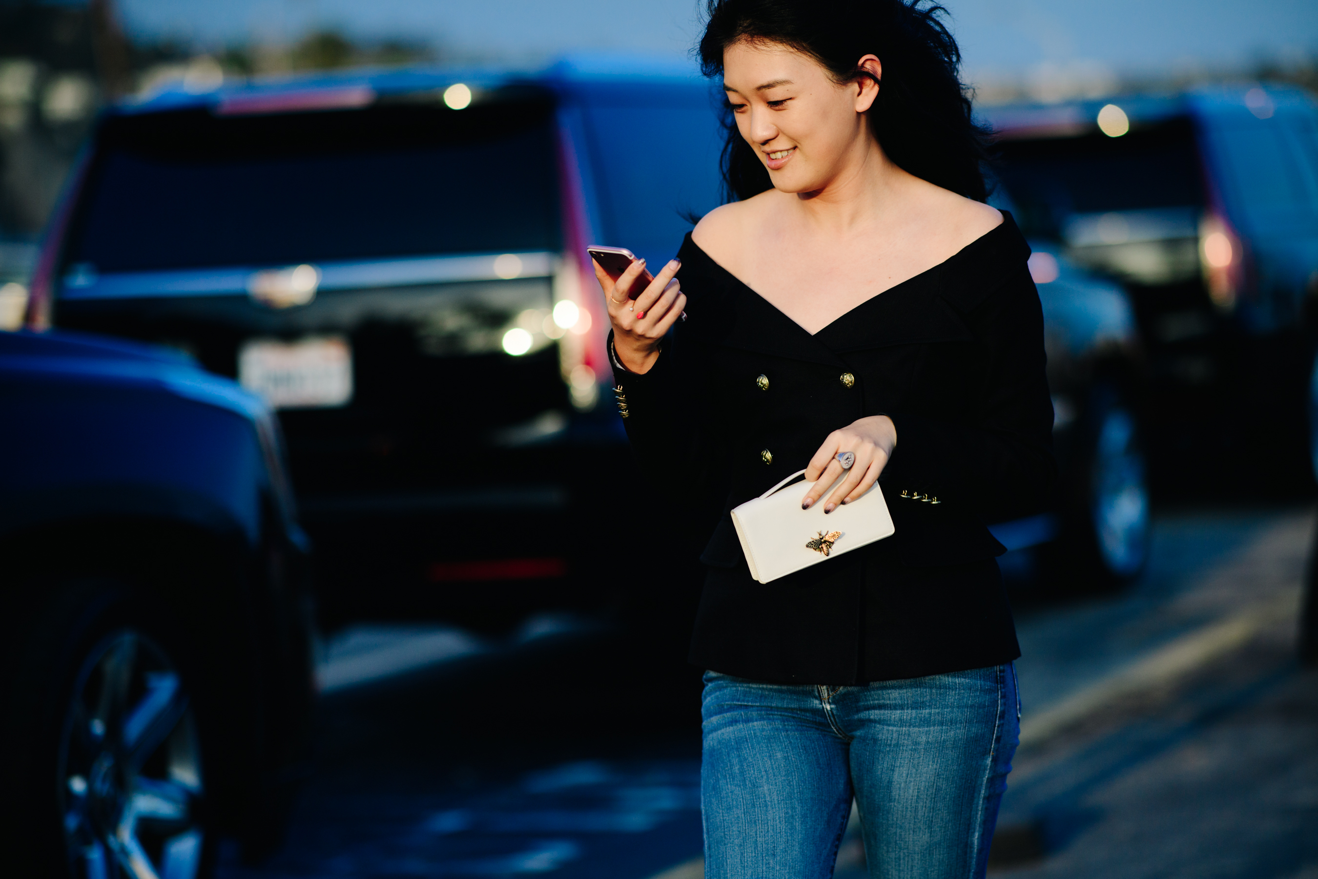 A woman carrying a Dior clutch