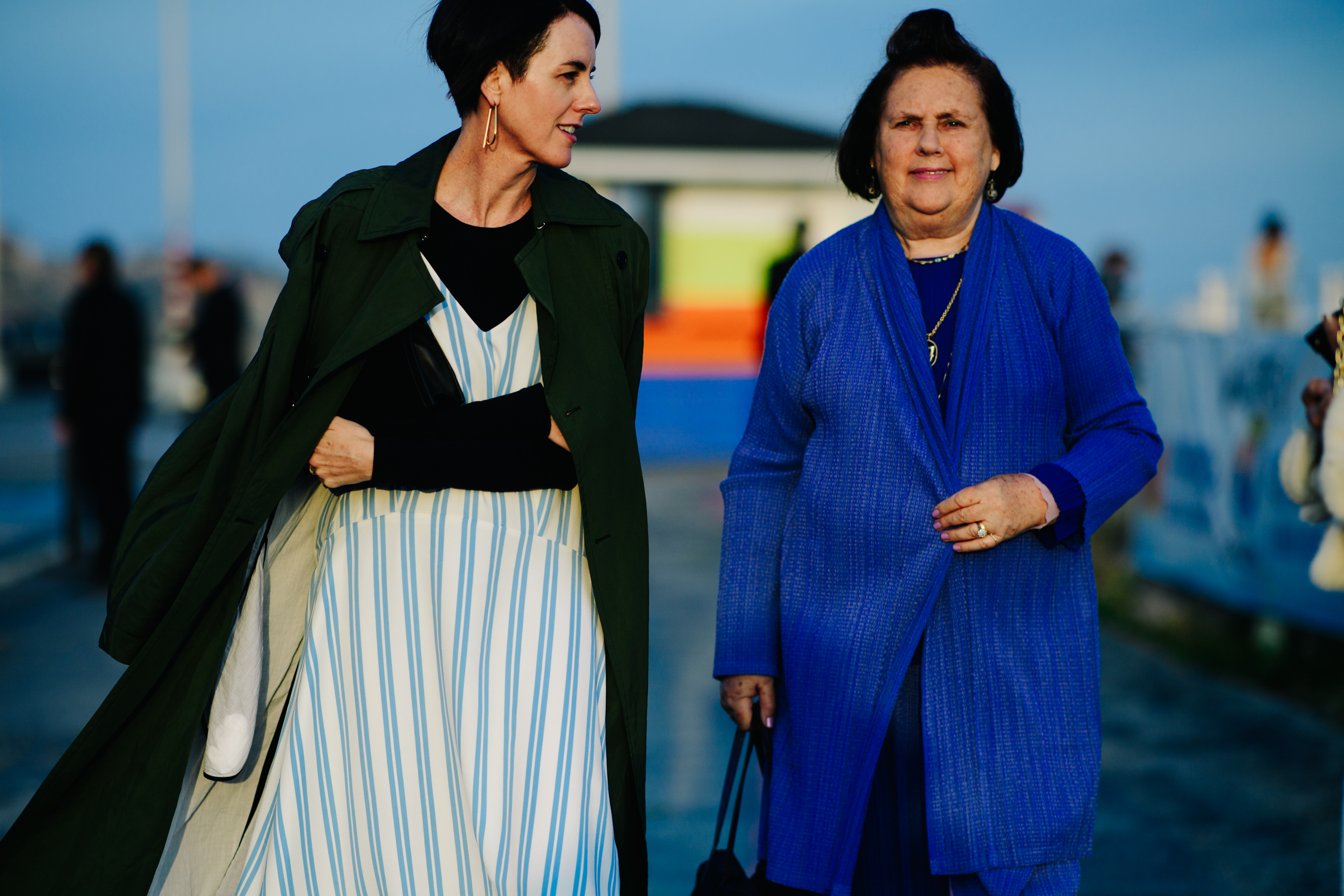 Two women walking down the pier