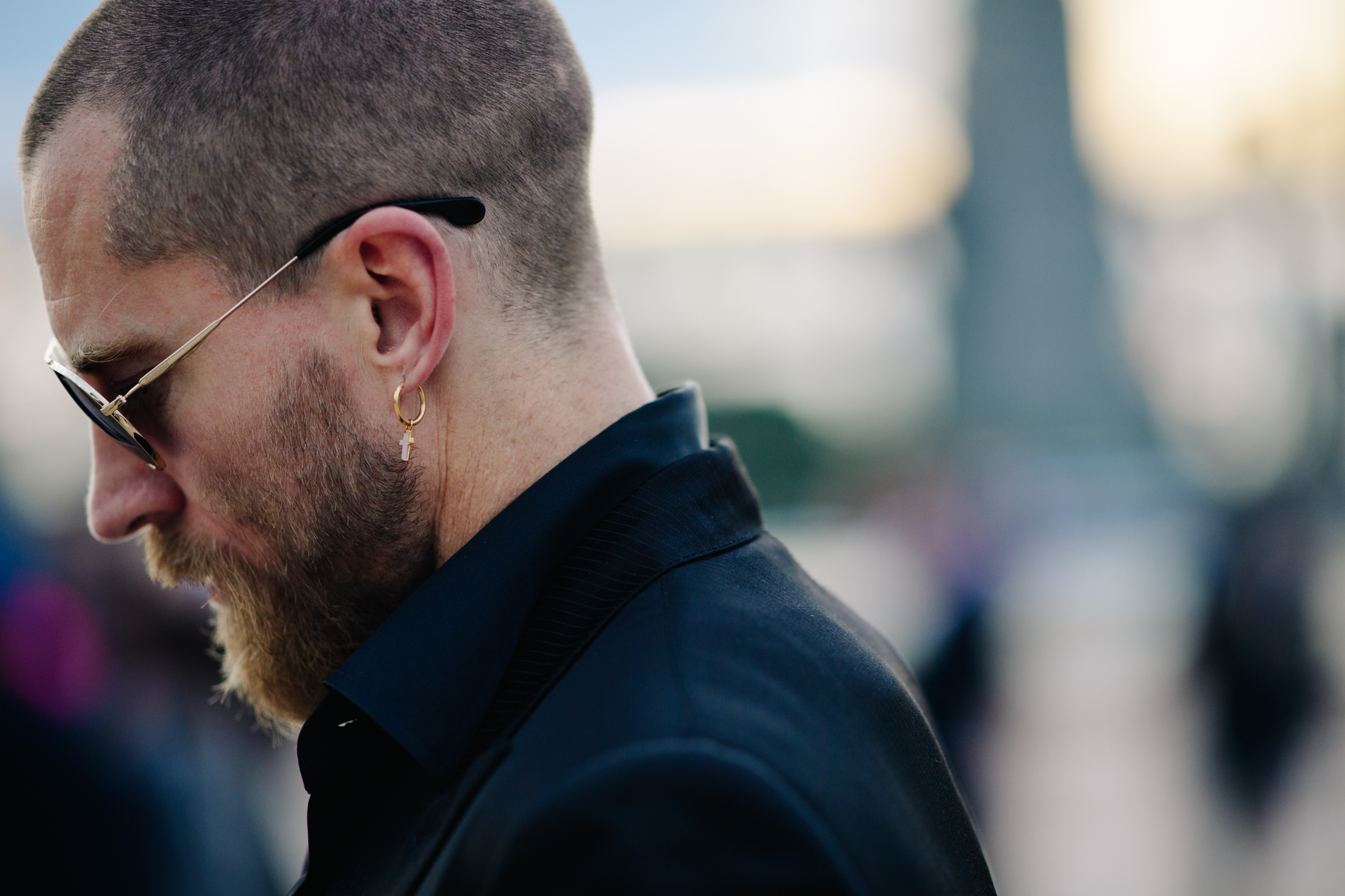 Man wearing glasses and earring