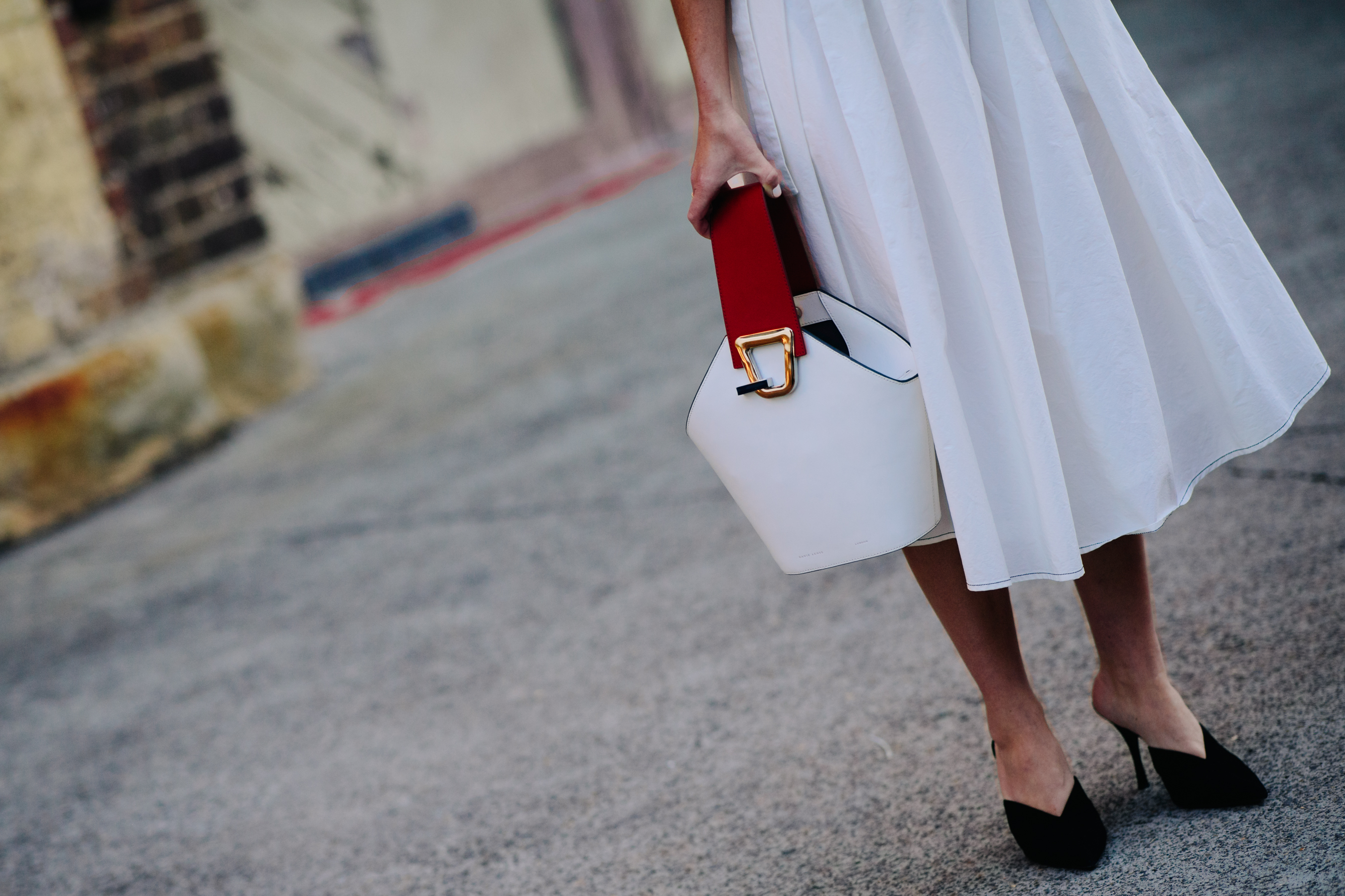 Woman carrying a white leather bag