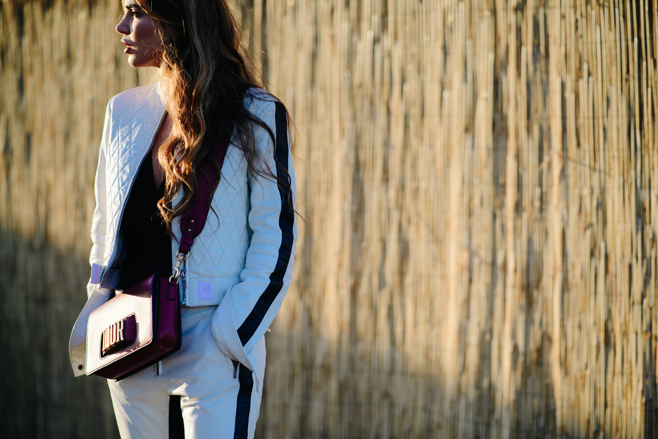 Woman wearing a purple Dior purse