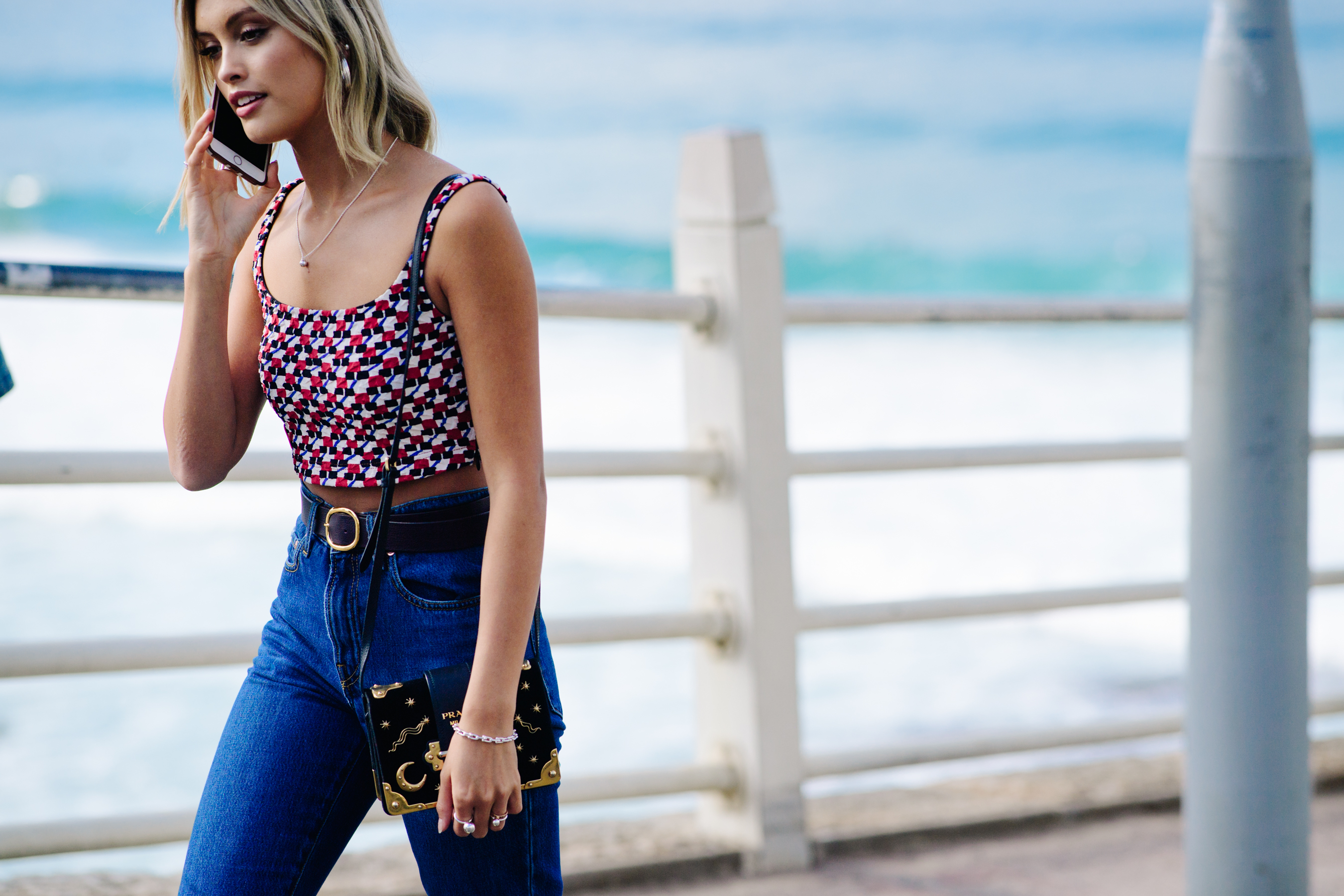 Girl carrying a Prada clutch