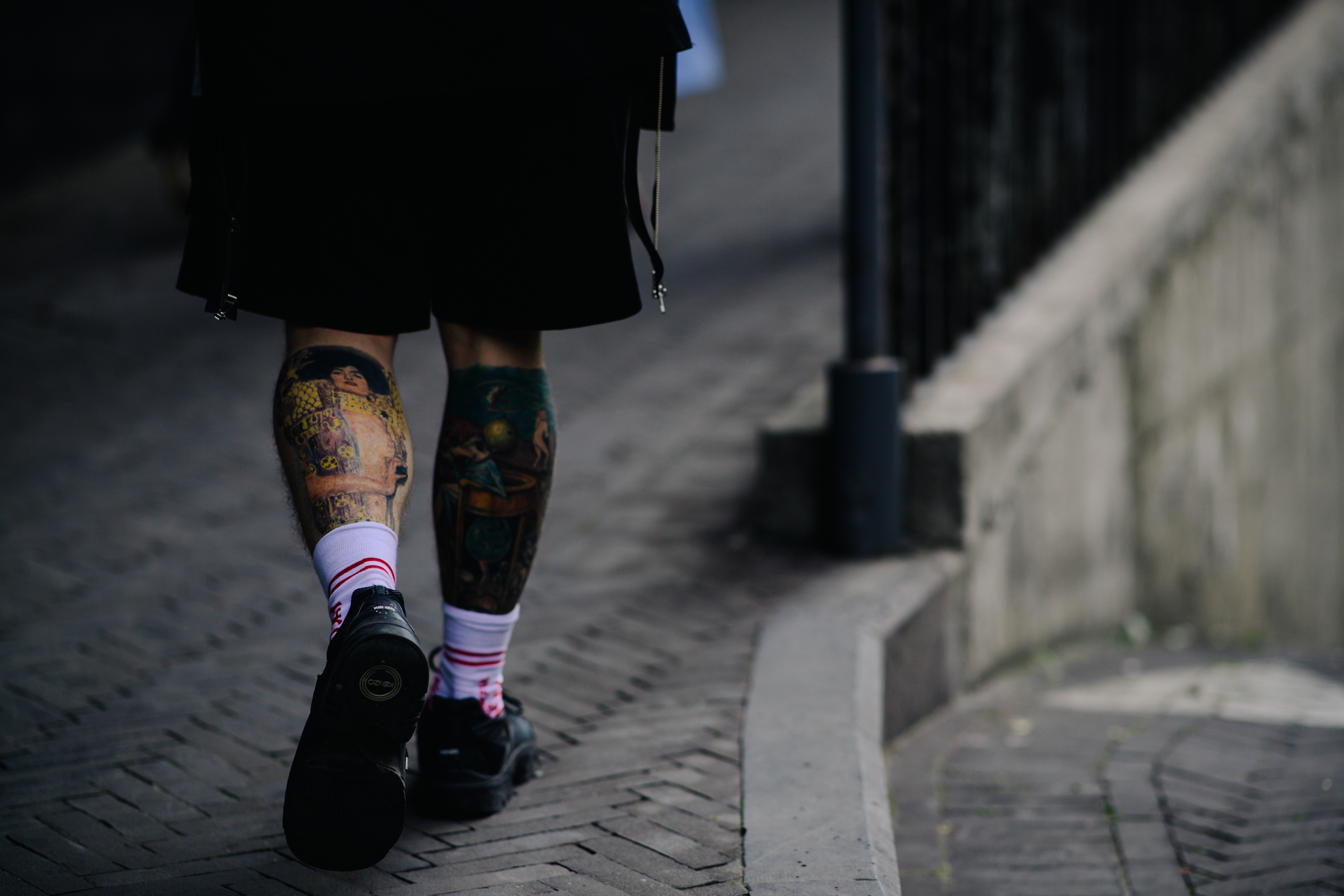 Tattoed boy wearing black shorts