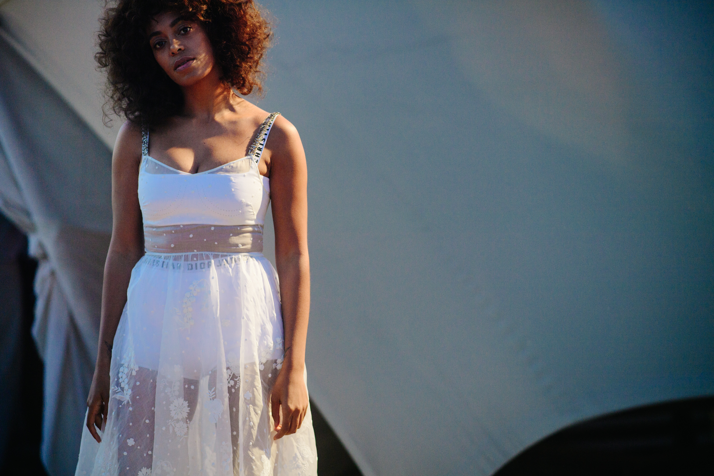 Singer wearing a white dress