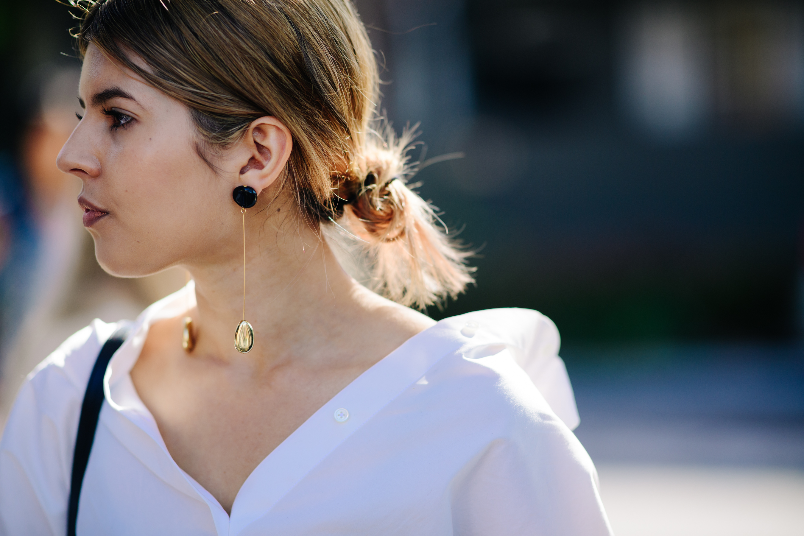 Woman wearing pendant golden earrings