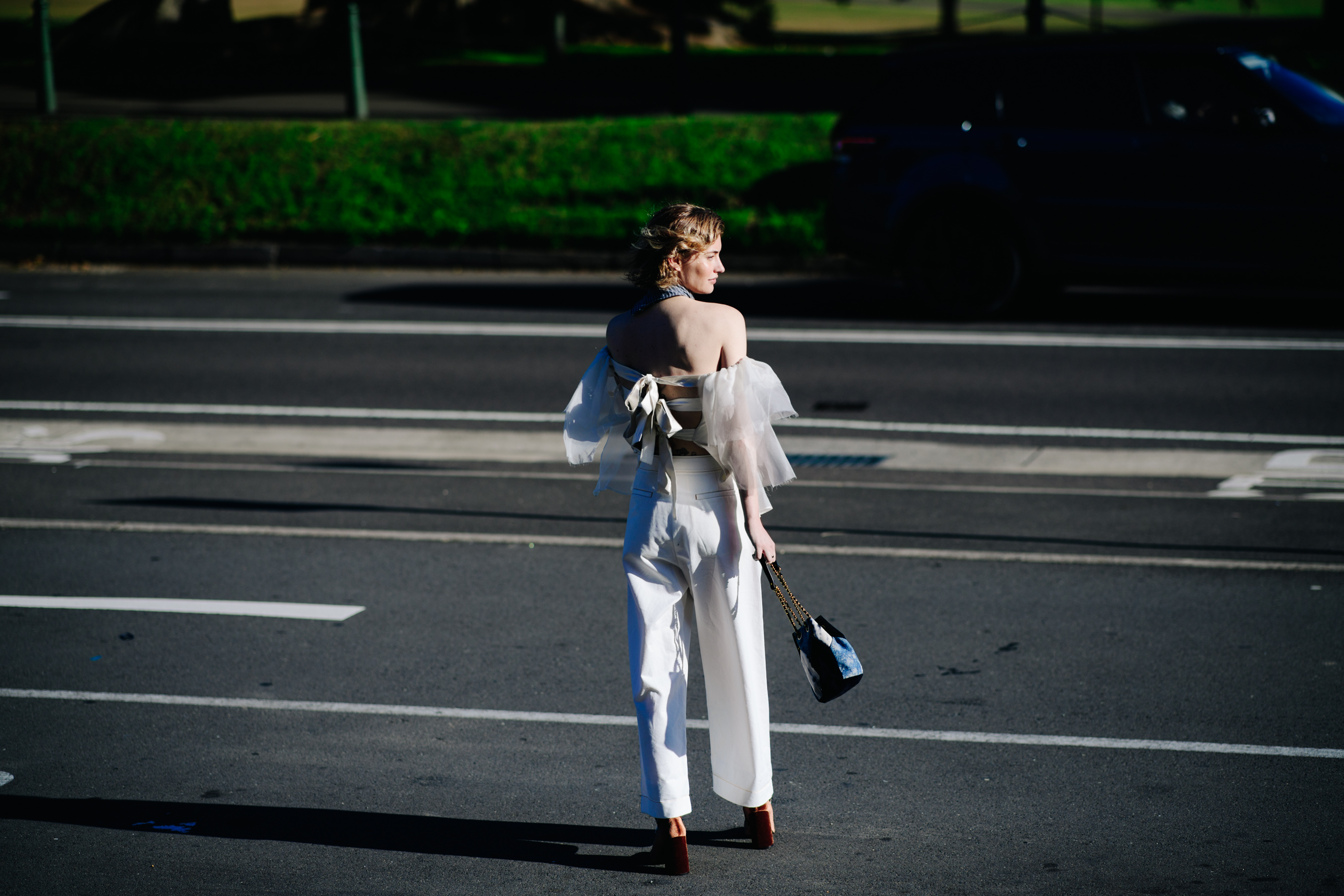 Woman wearing large white trousers