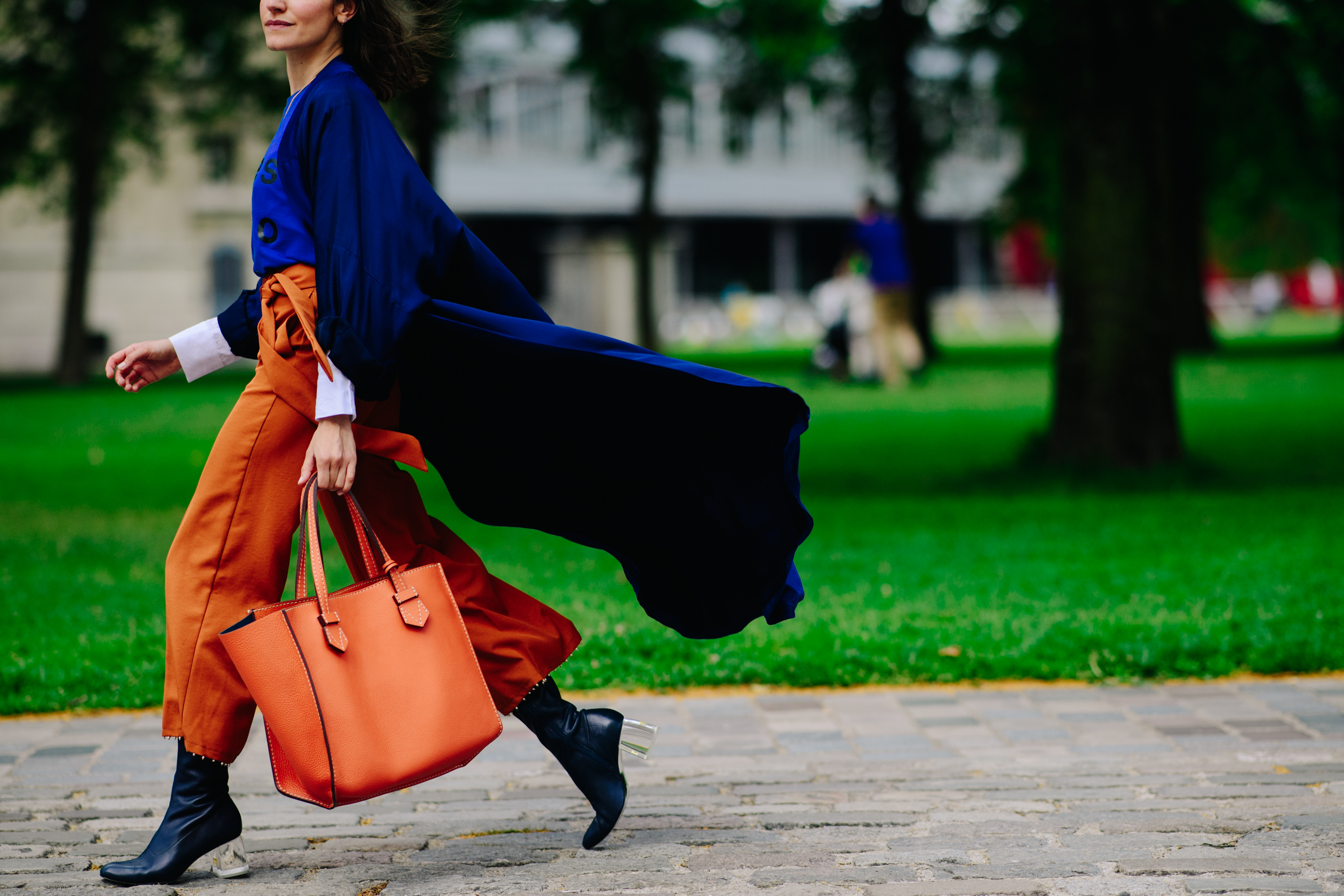 Woman carrying a leather orange bag