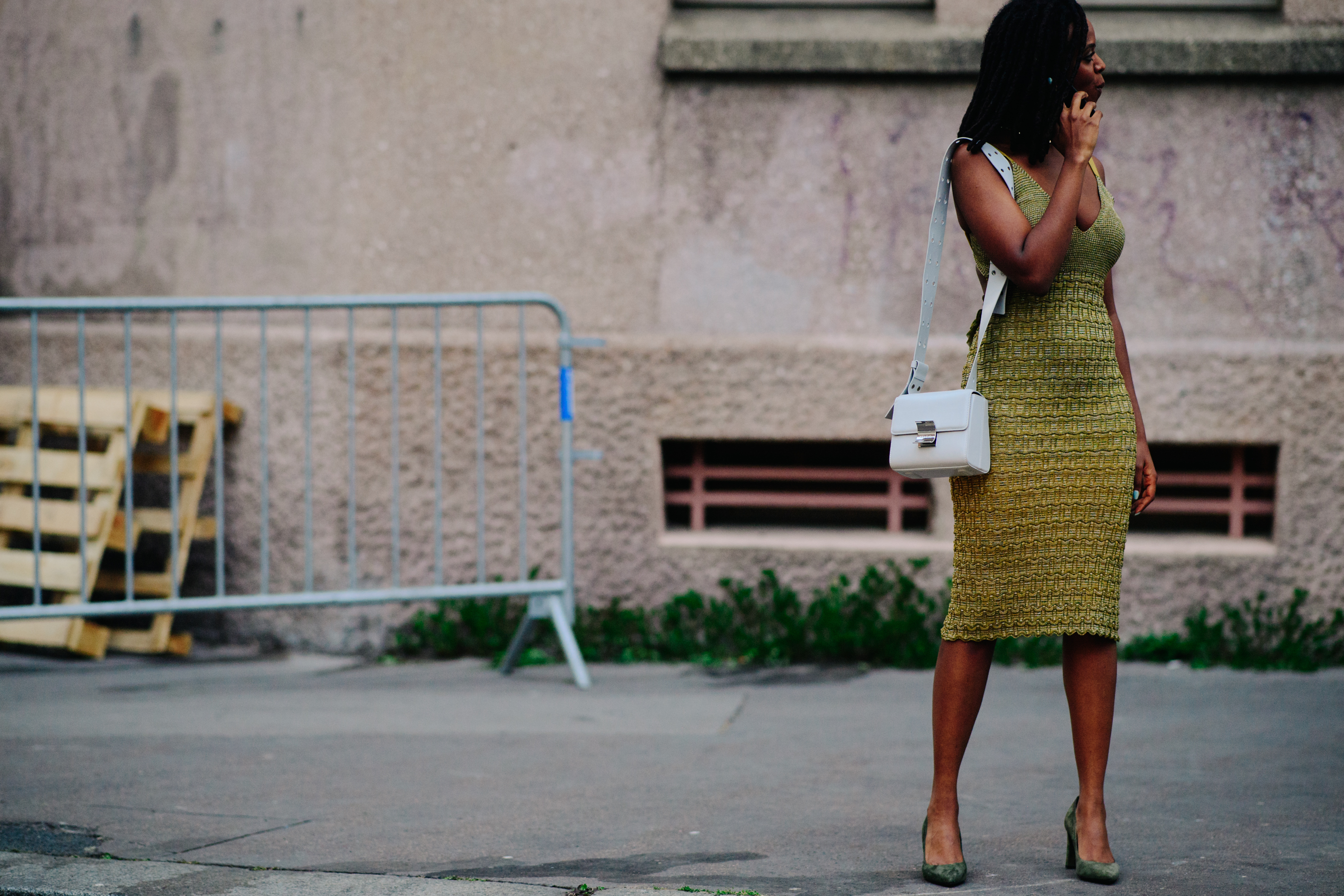 Woman carrying a white leather clutch