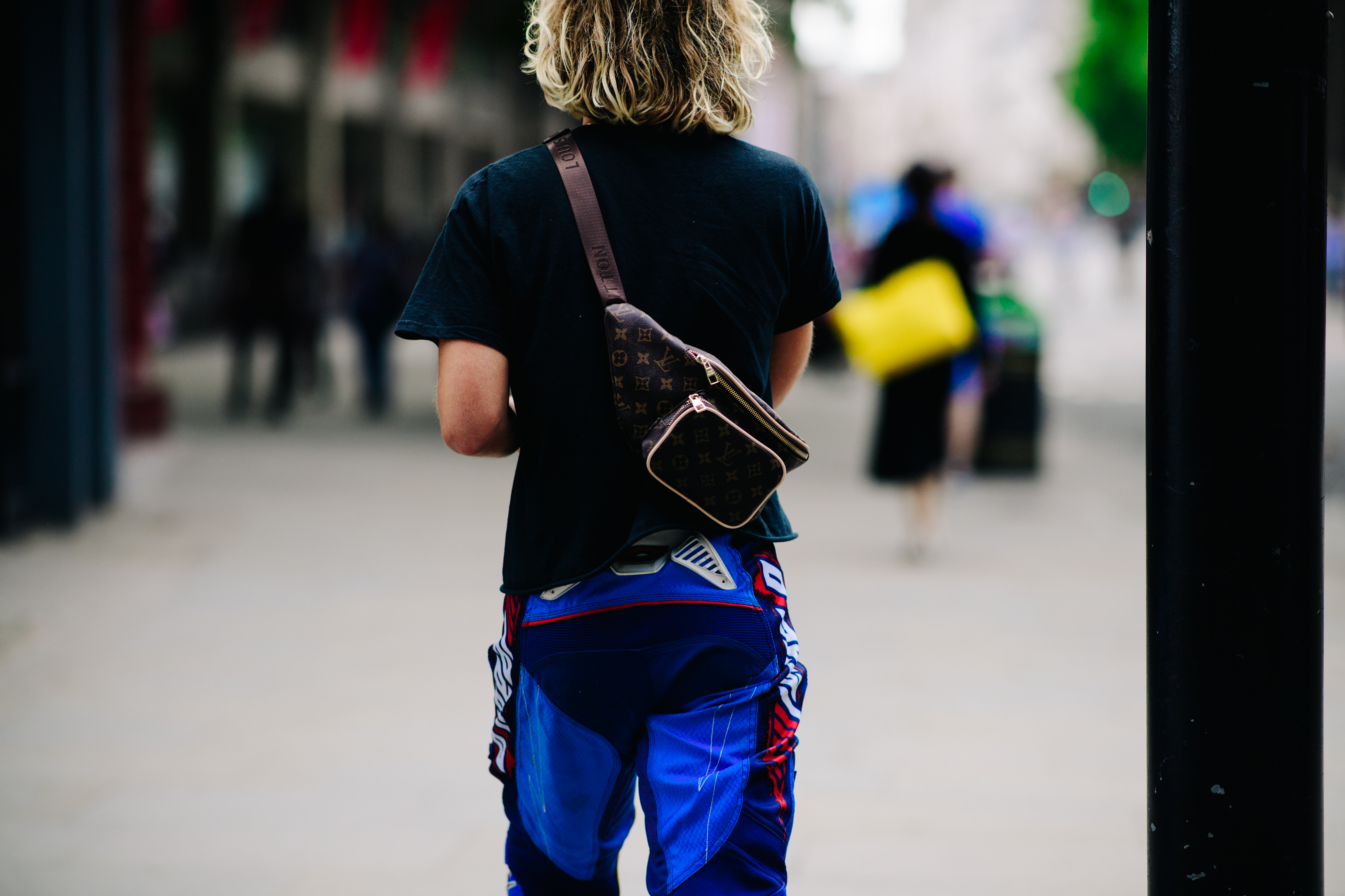Boy wearing a Louis Vuitton bag