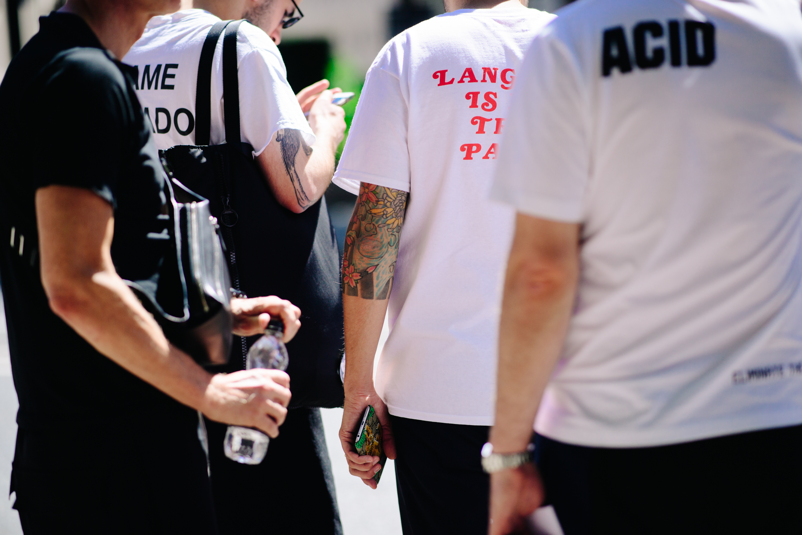 Guys wearing white printed t-shirts