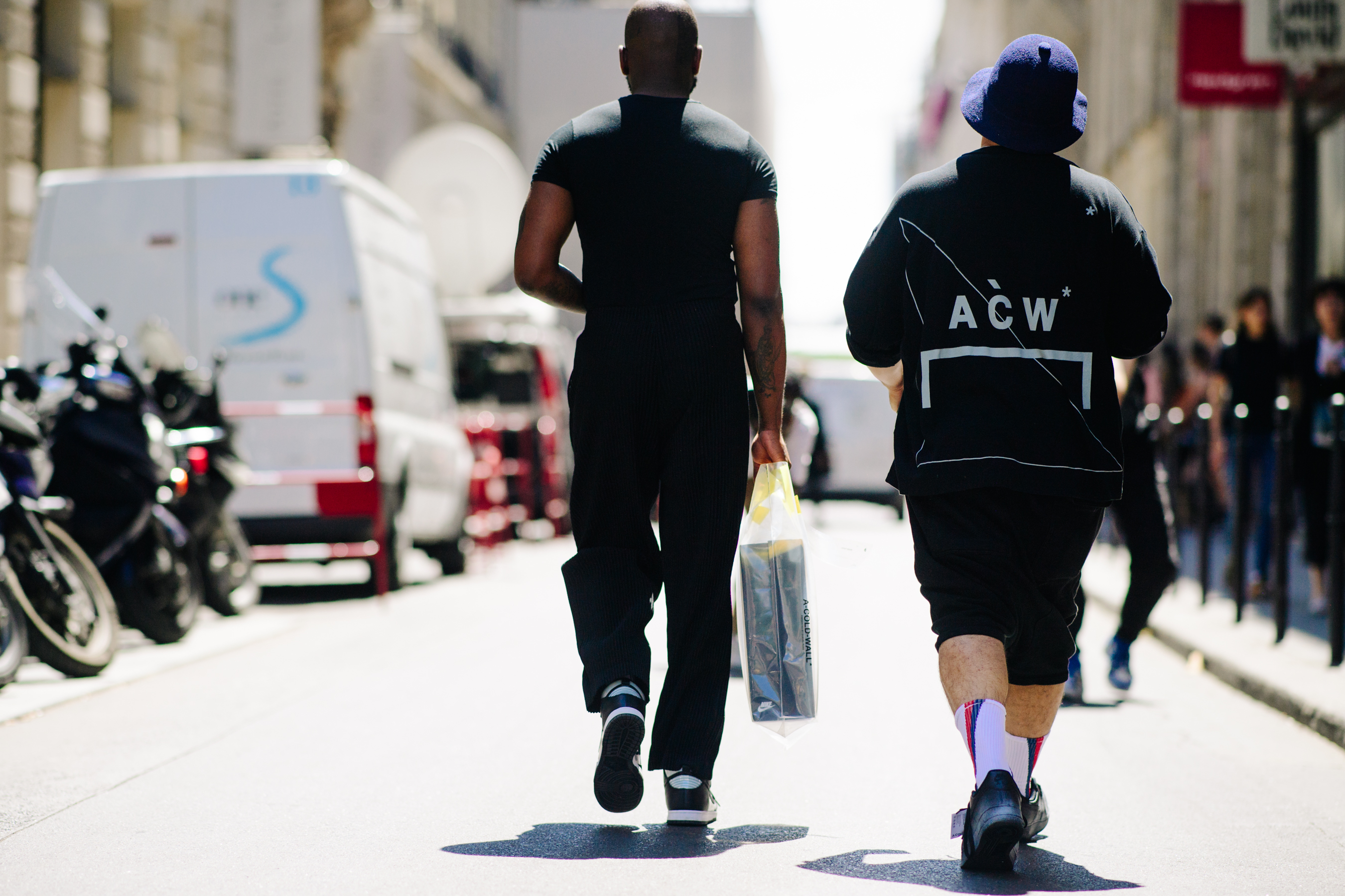 Two men wearing dark outfits