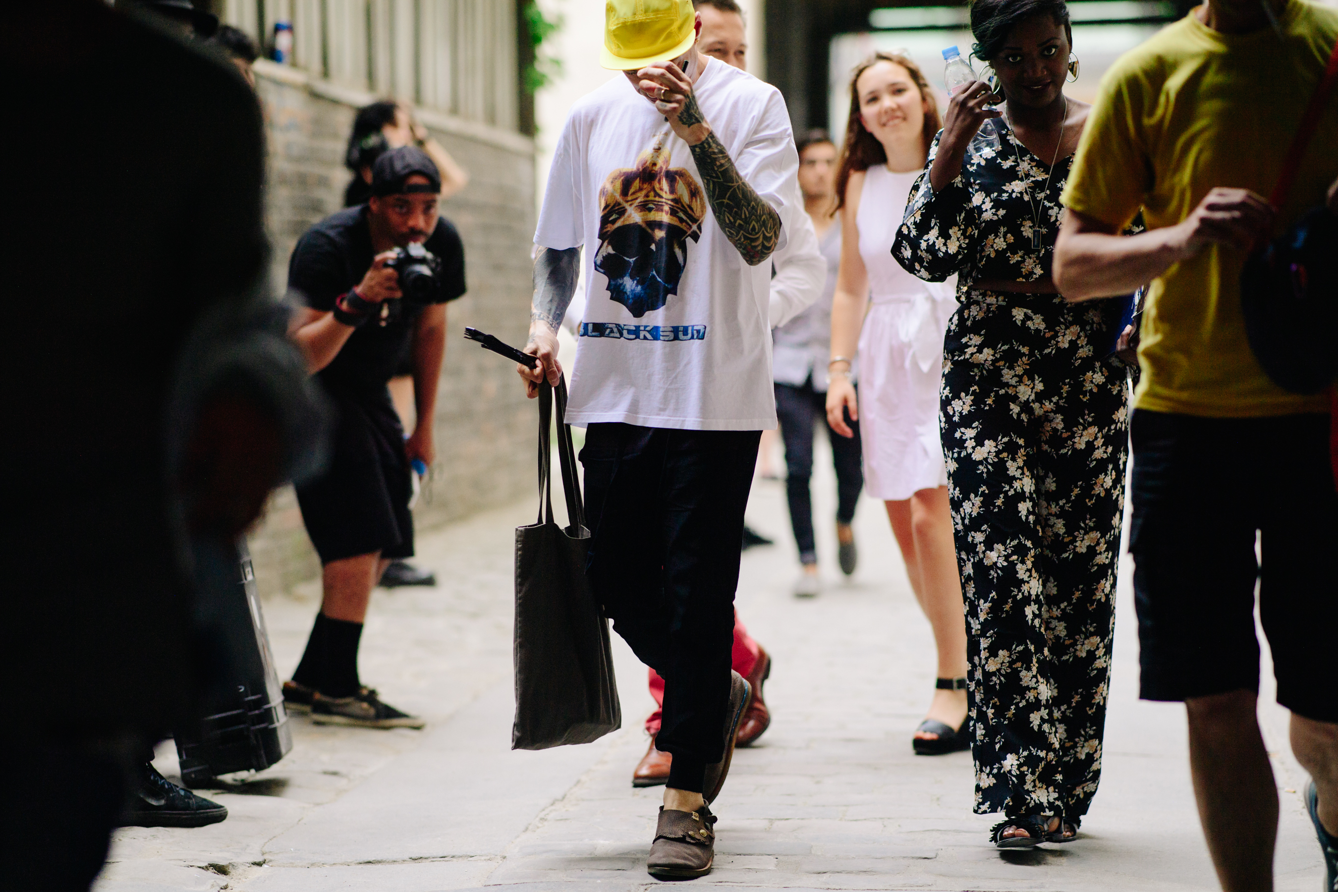 Tattooed man wearing a yellow cap