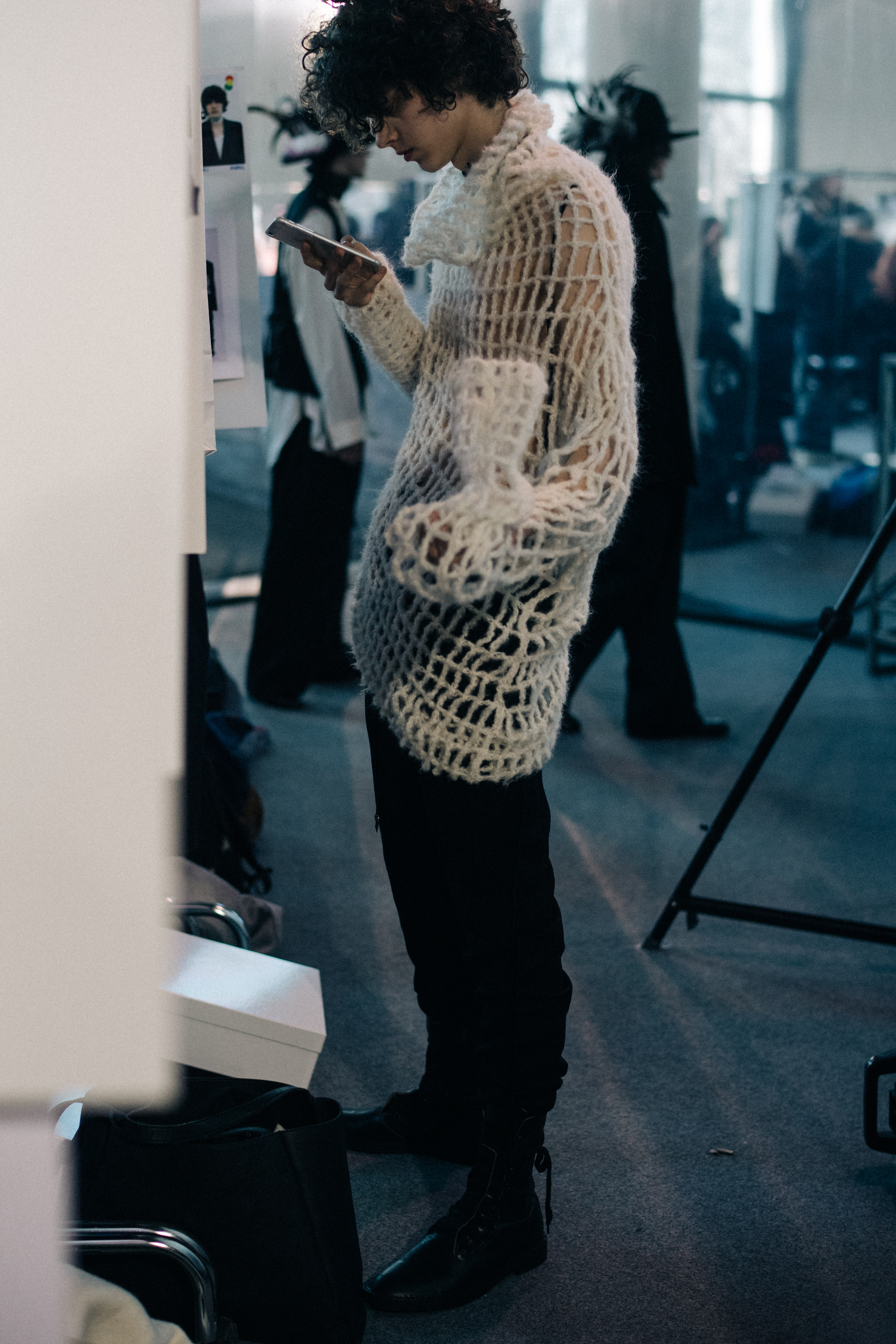 Male model wearing white sweater