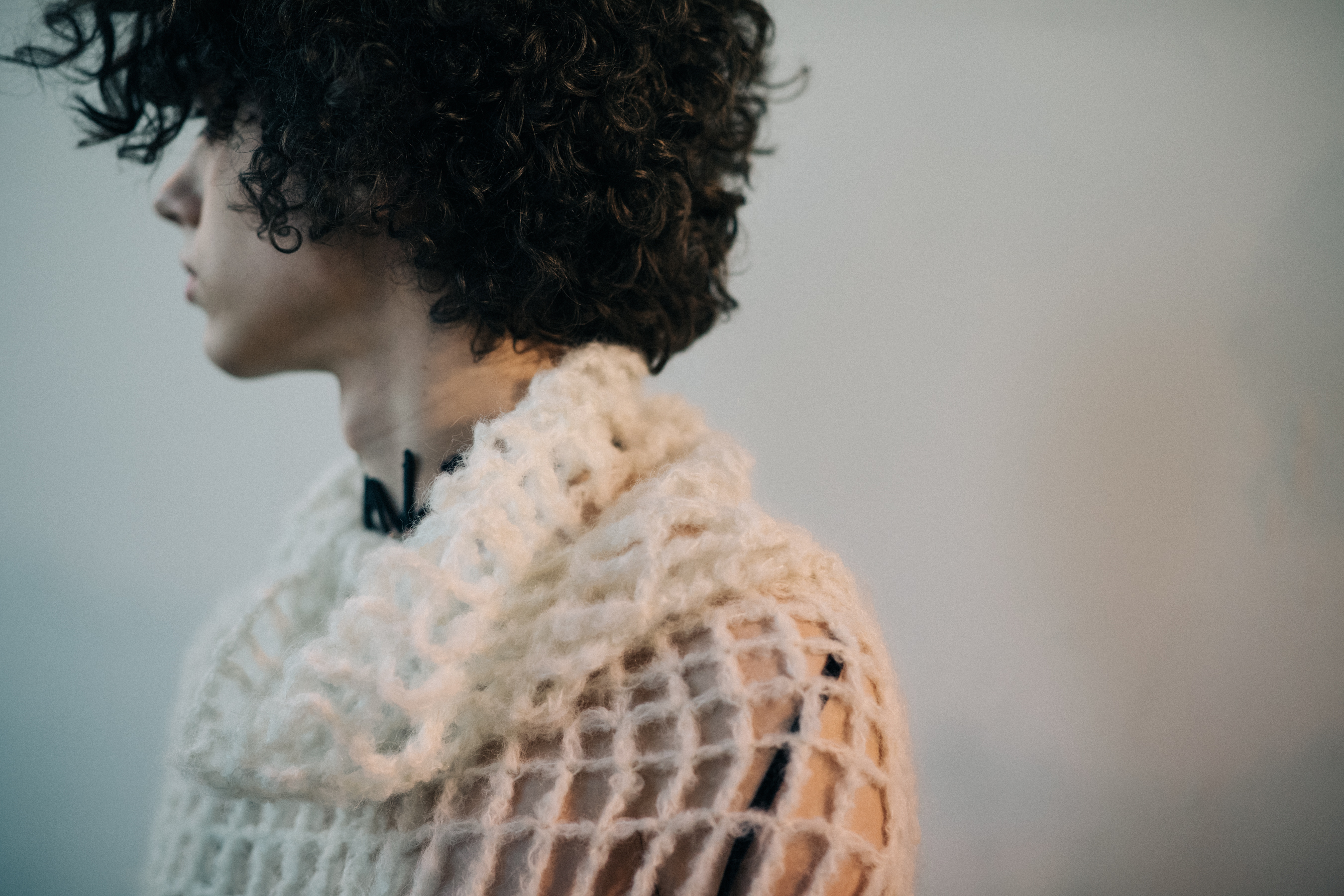 Male model wearing white sweater