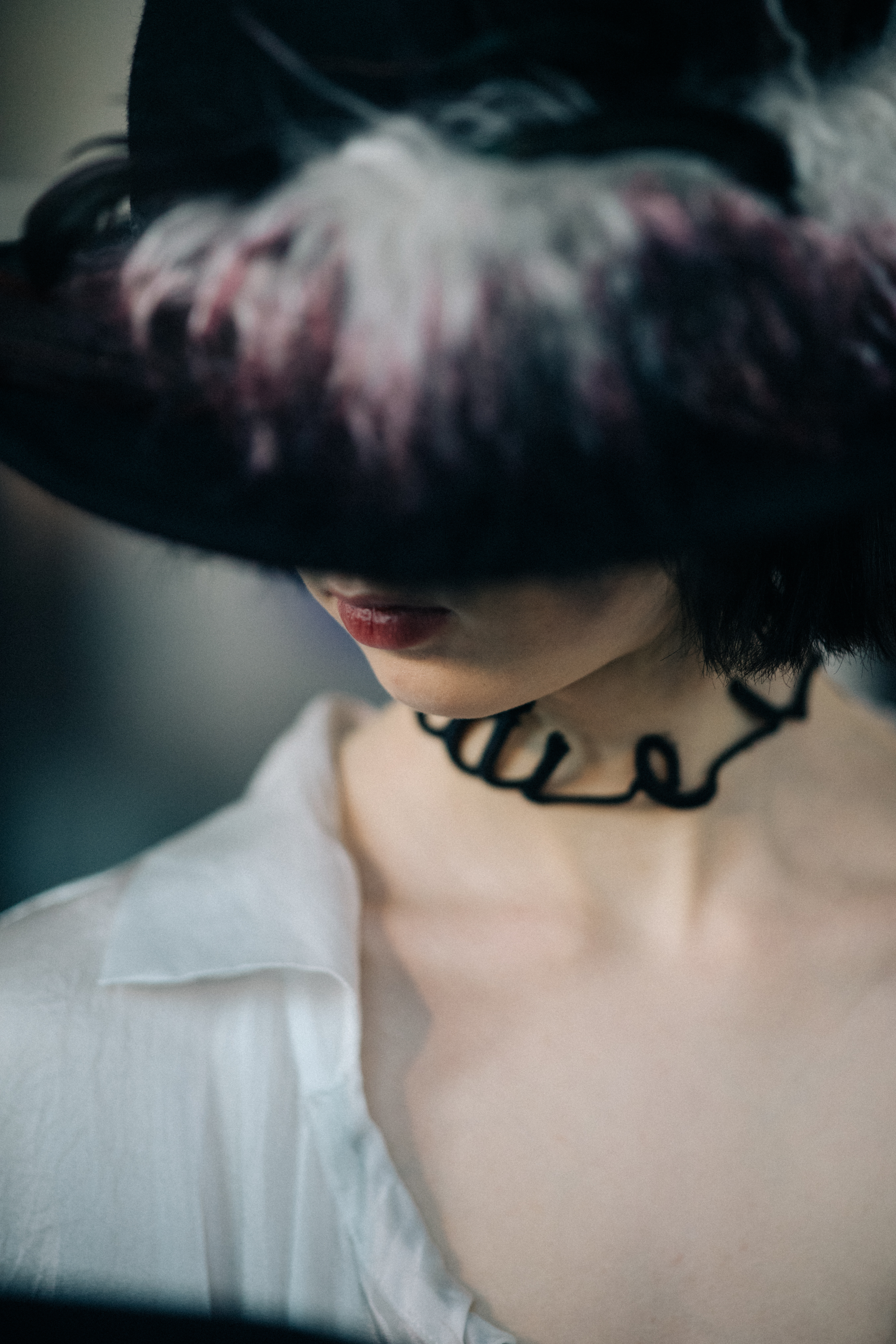 Model wearing hat with feathers