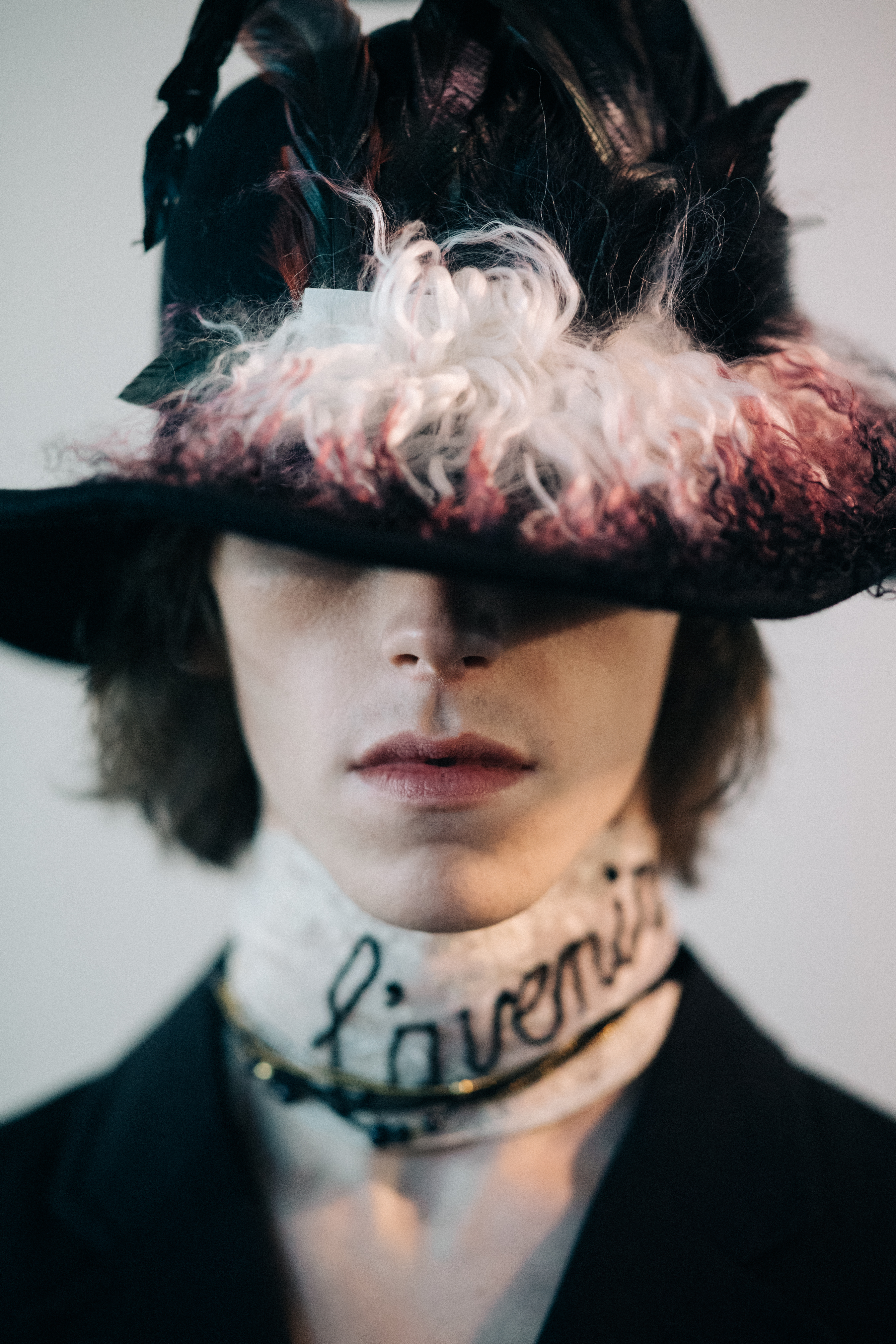 Portrait of a male model wearing feather hat