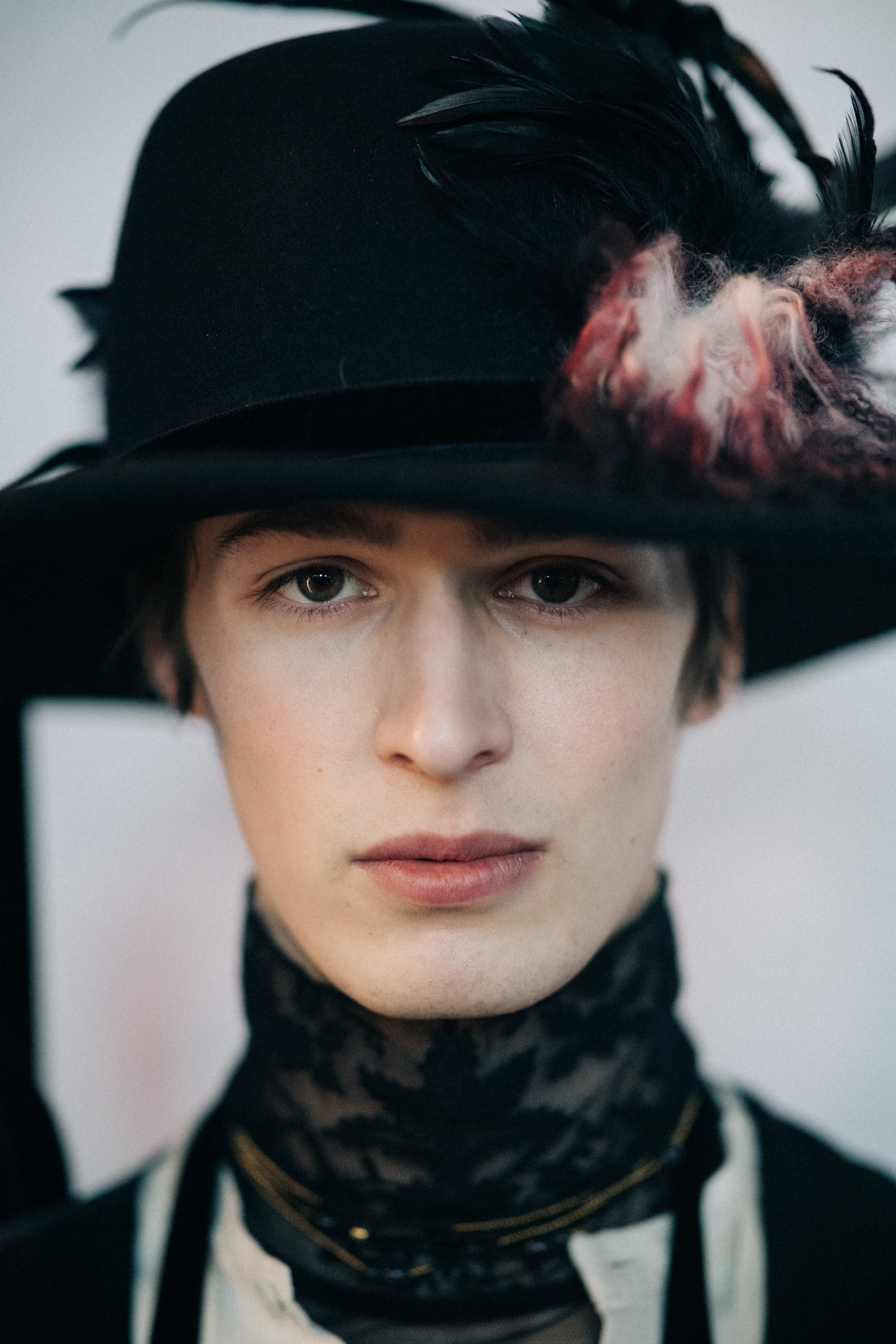 Portrait of a male model wearing feather hat