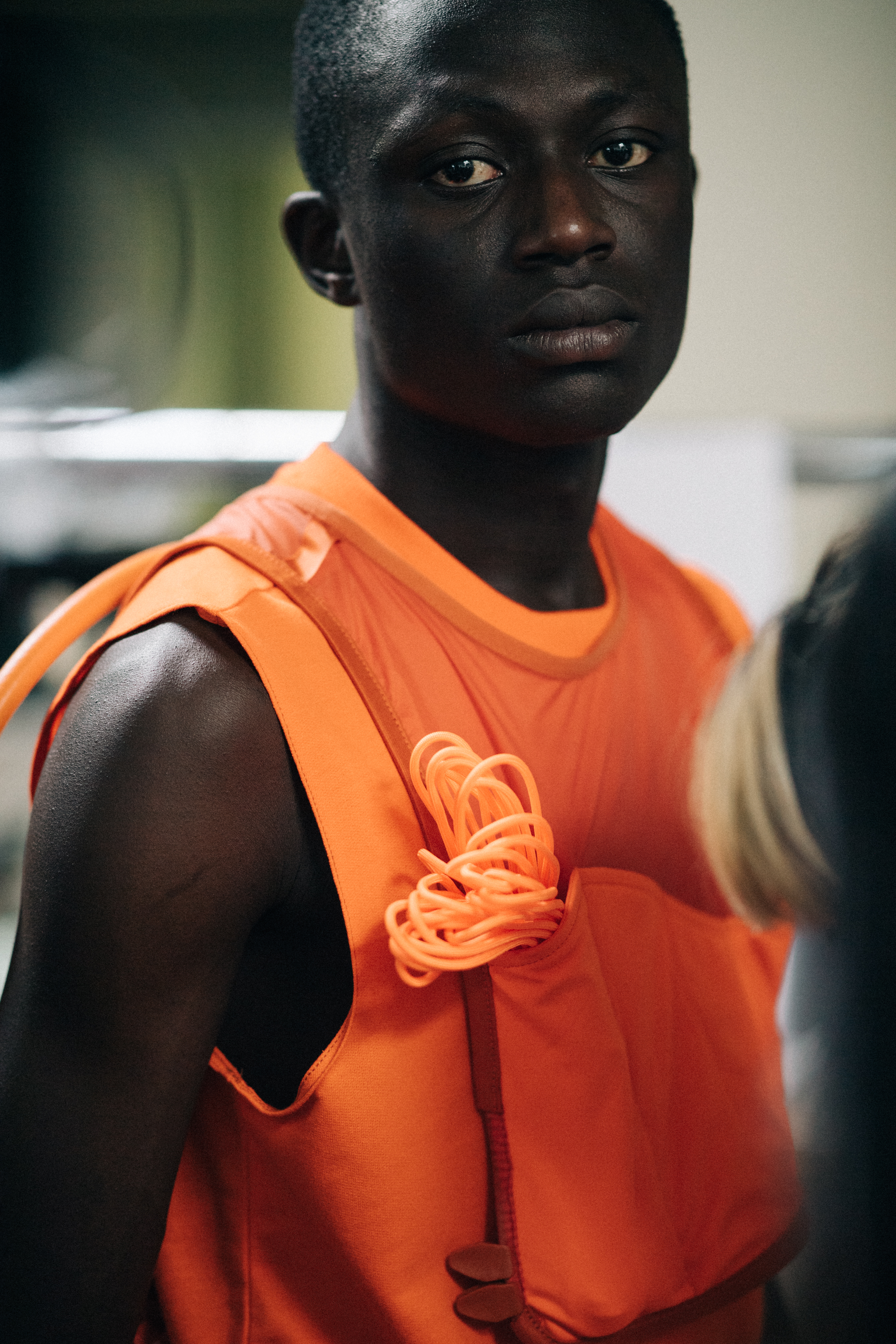 Model wearing a bright orange gilet