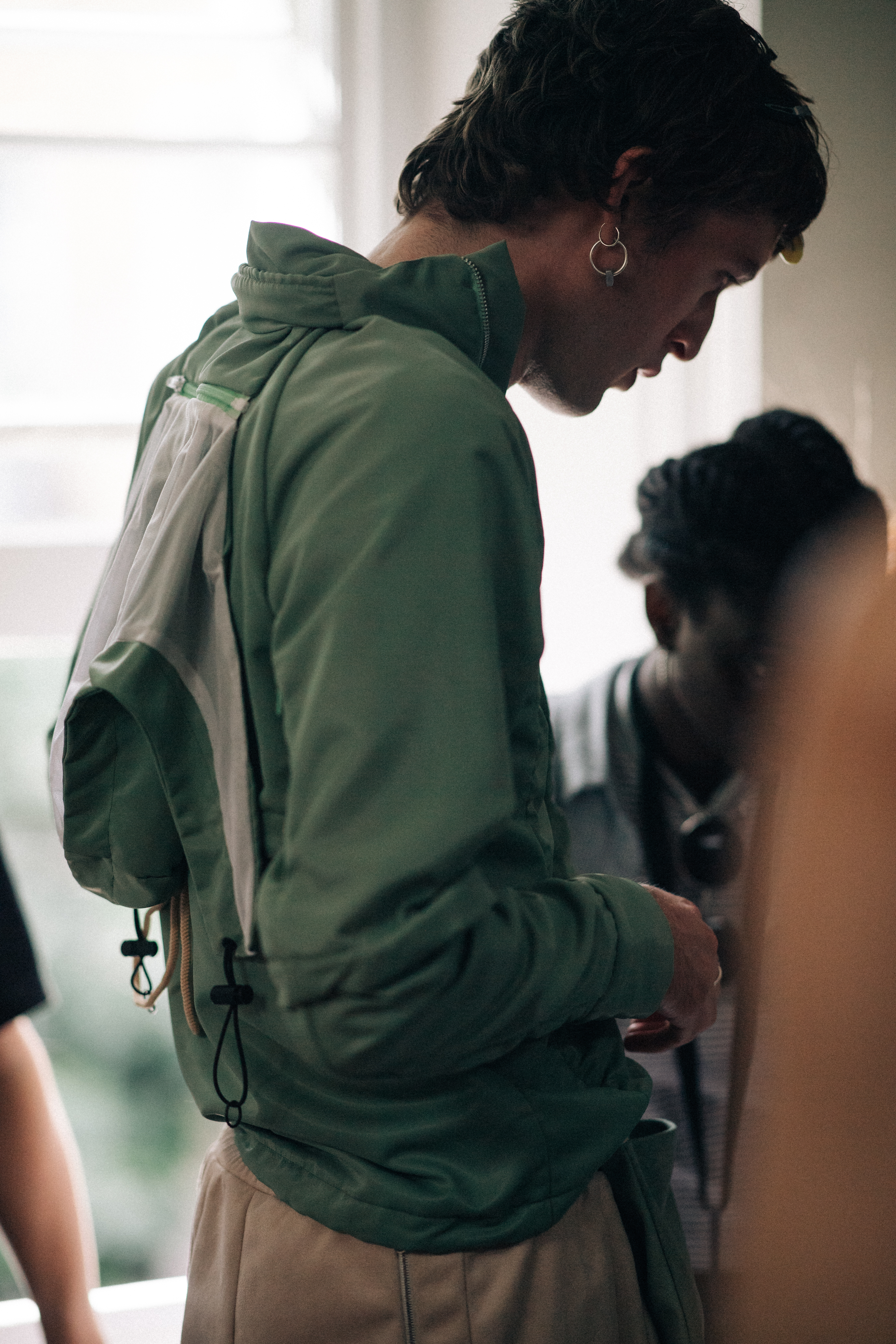 Male model wearing a green vest