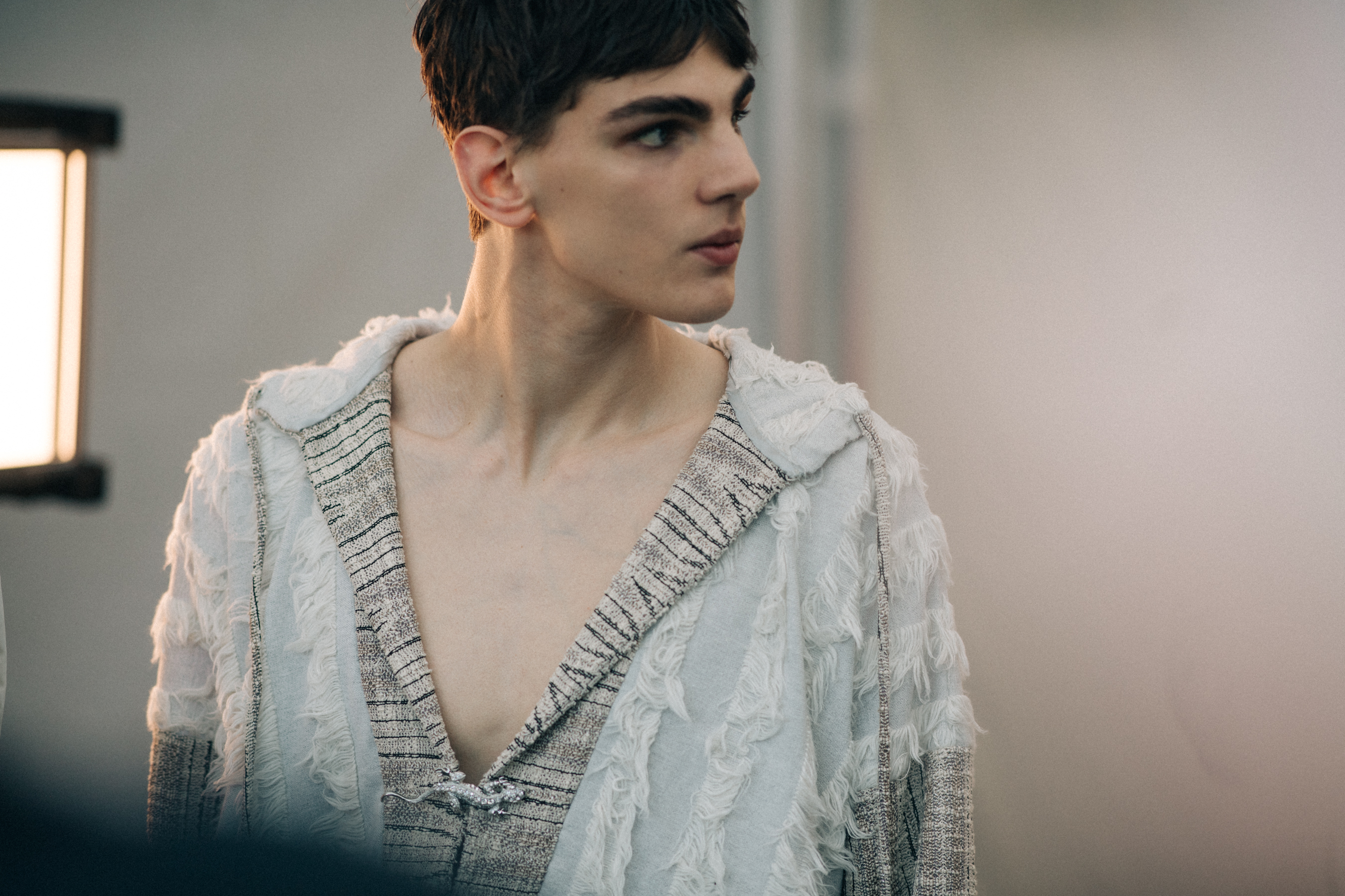 Male model wearing a distressed hoodie