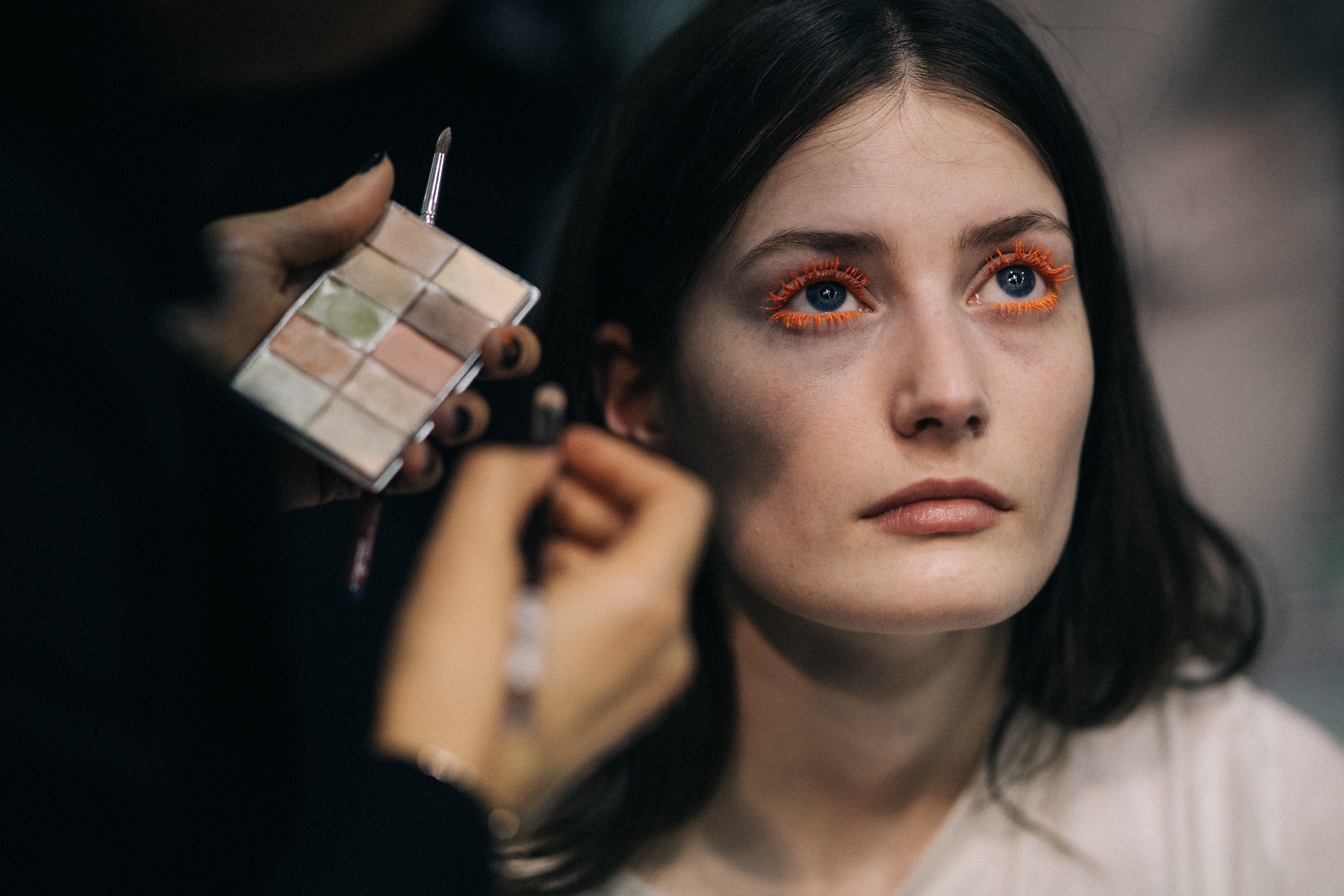 Model getting final make-up retouches