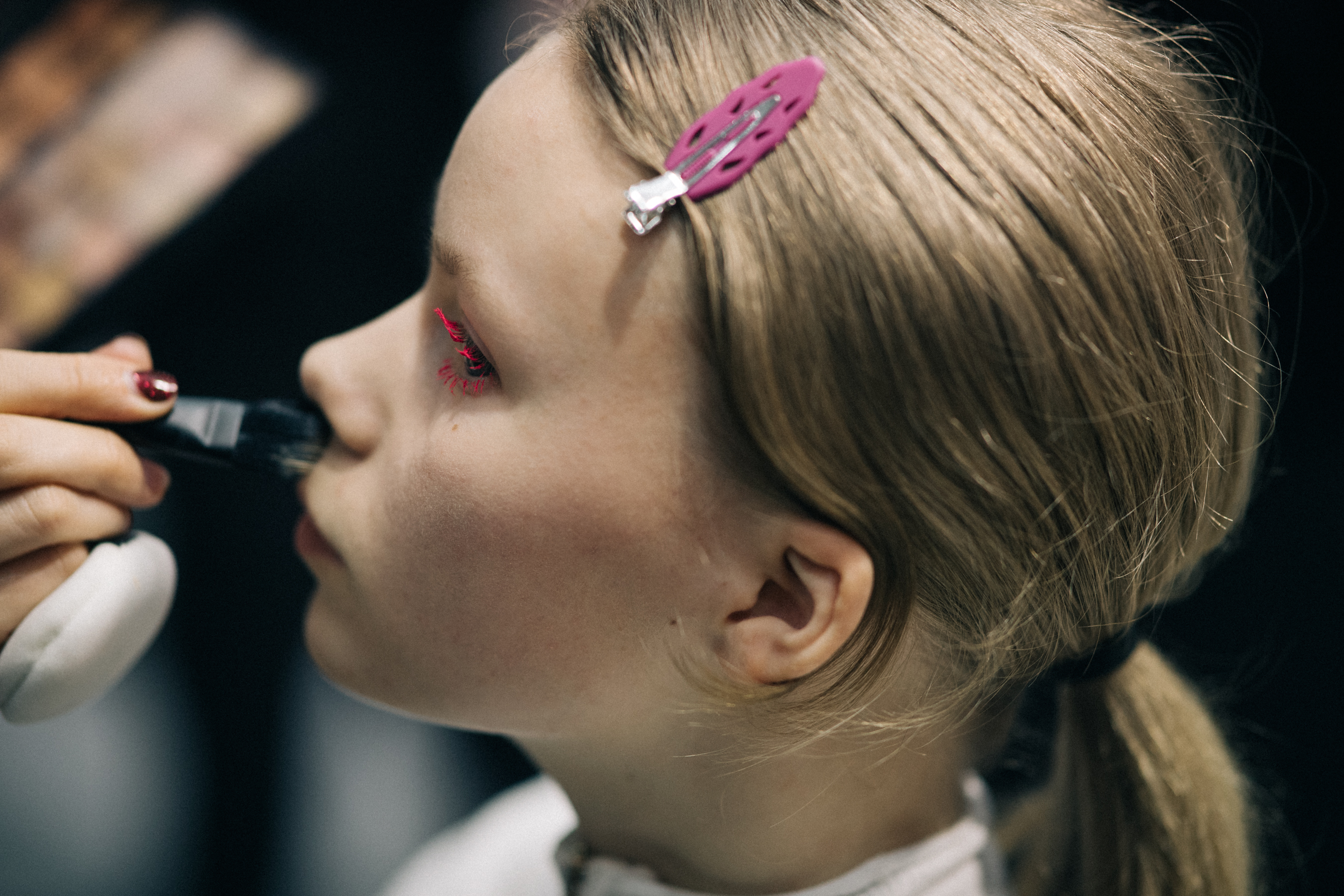 Model receives final make-up retouches