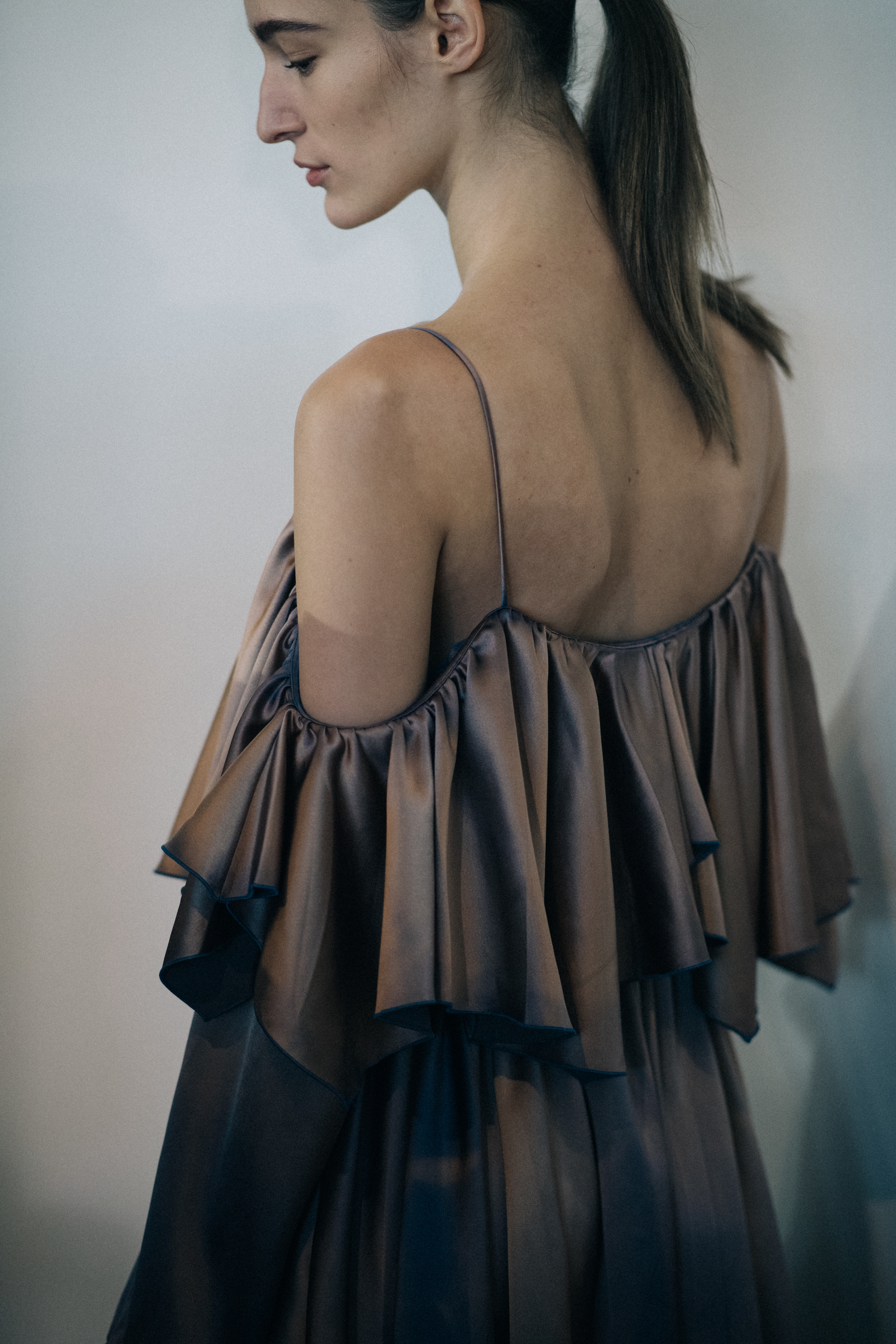 Model wearing silk ruffled dress