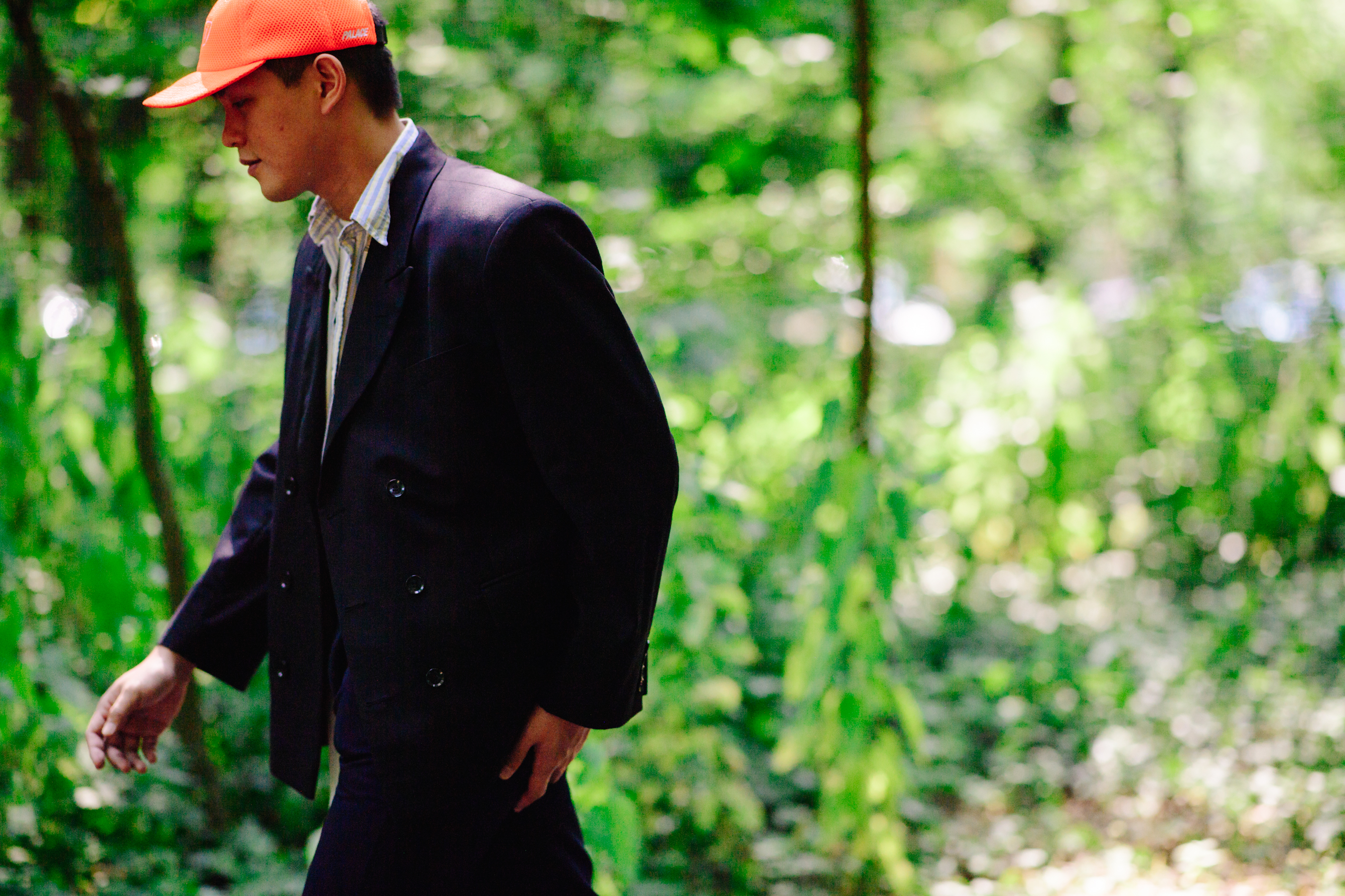 Man wearing an orange Palace cap