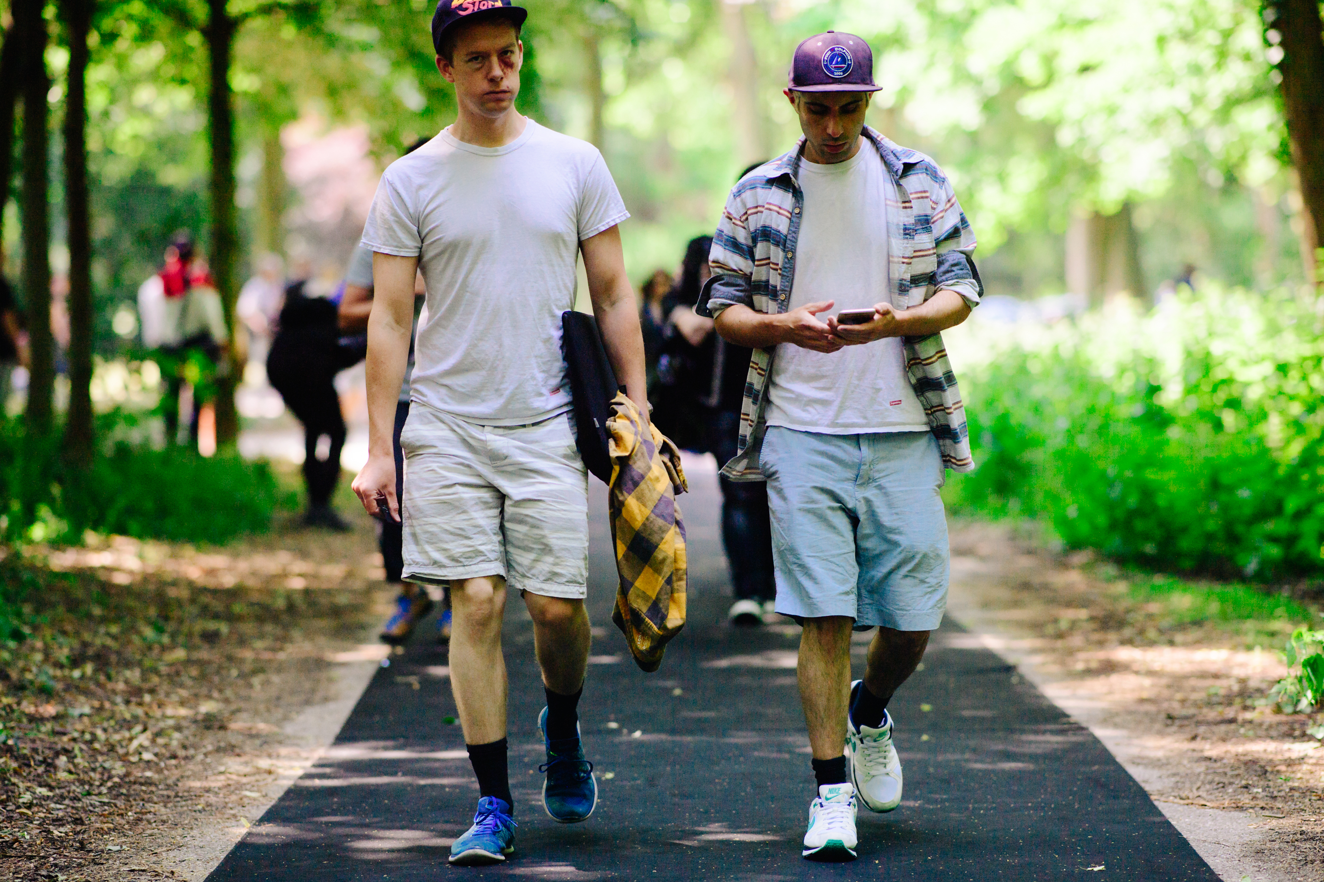 Two men wearing Nike and Supreme