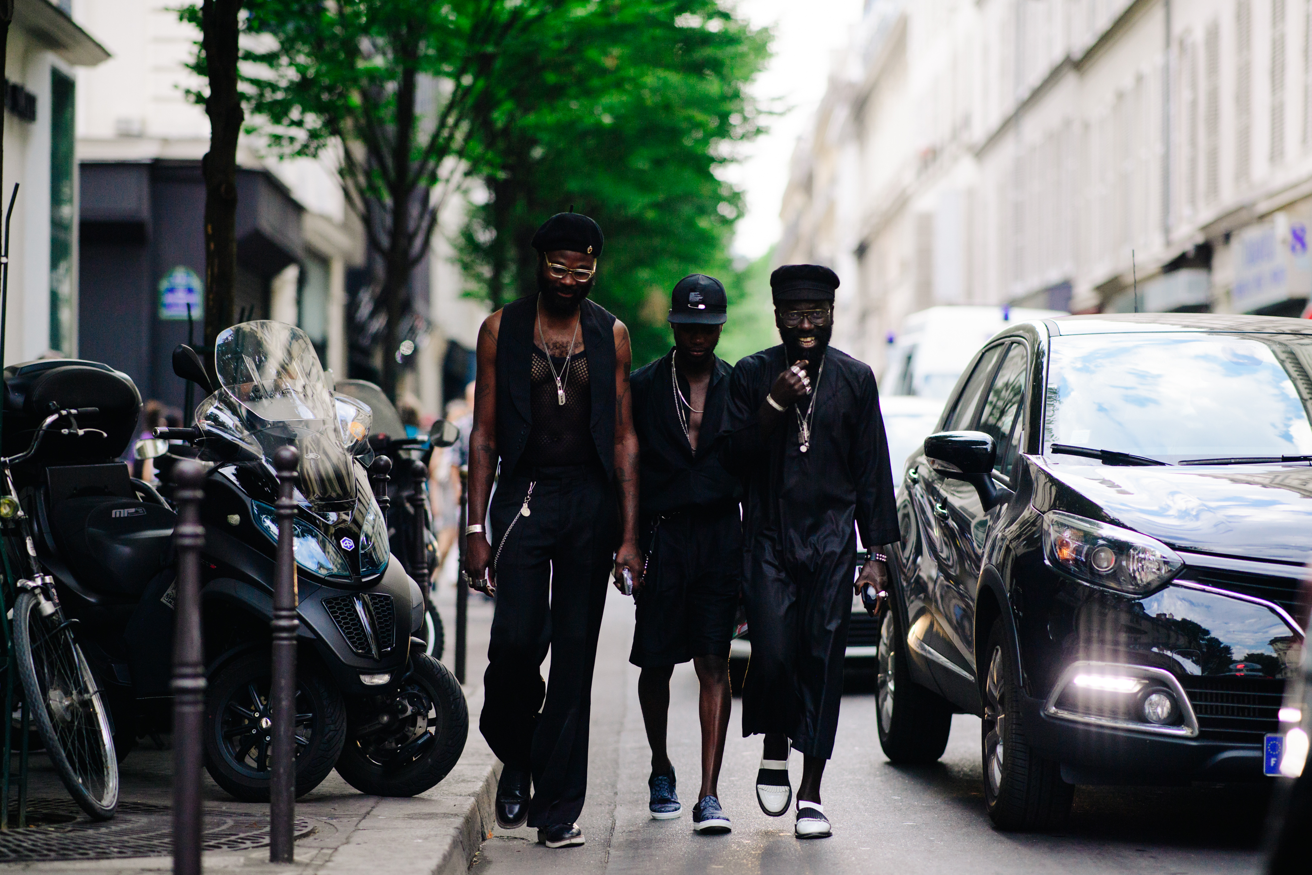 Three men wearing black outfits
