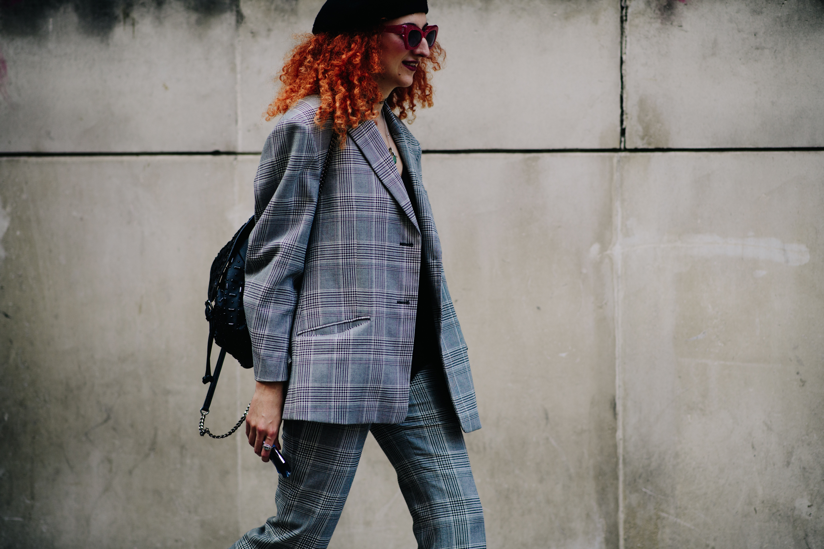 Woman wearing a grey tweed suit
