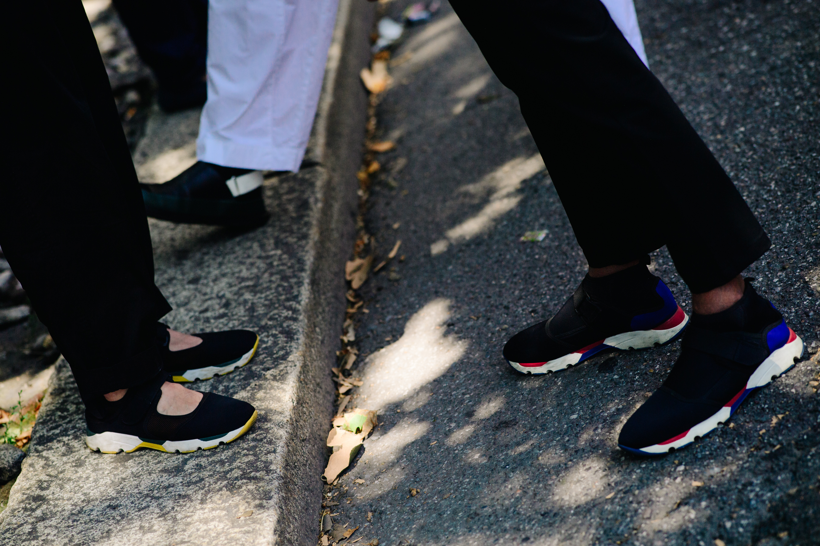 People wearing black sneakers
