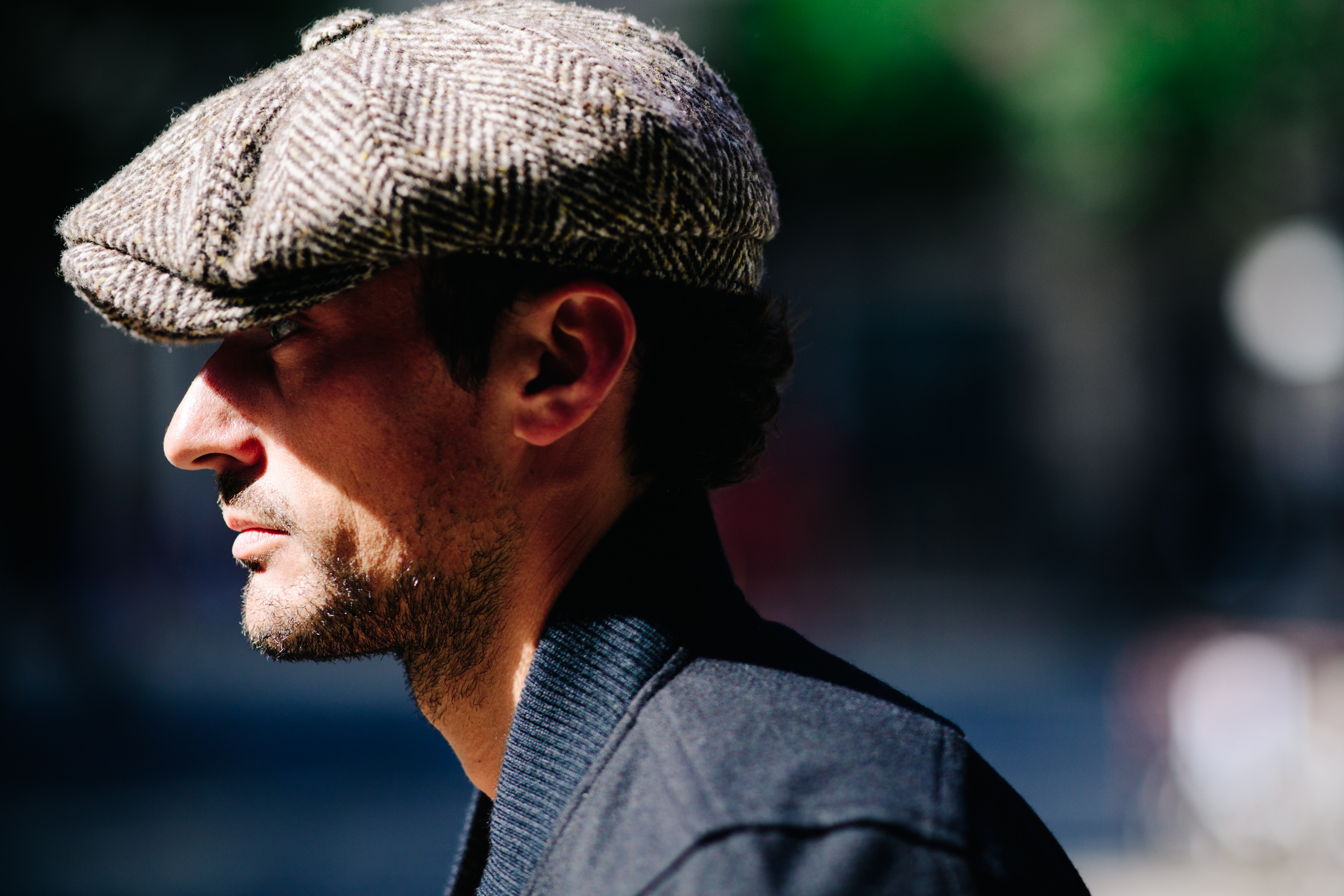 Profile of a man wearing grey cap