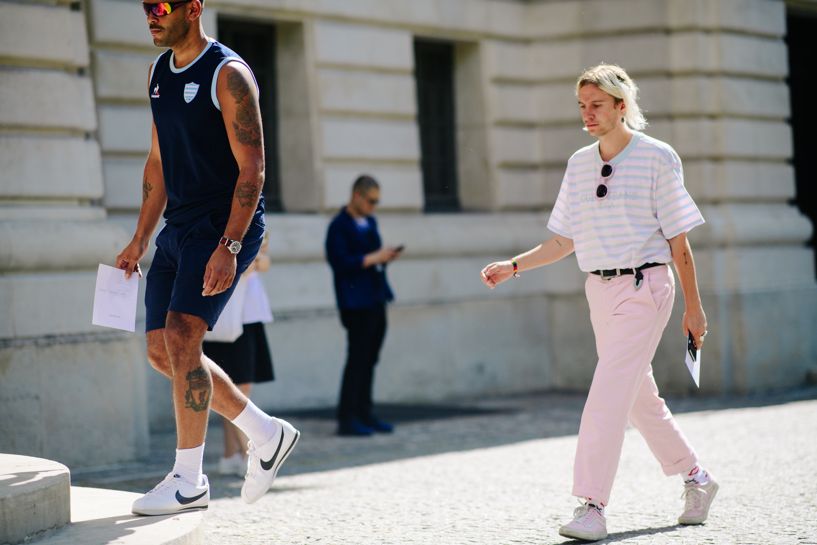 Man wearing pink trousers and Vans