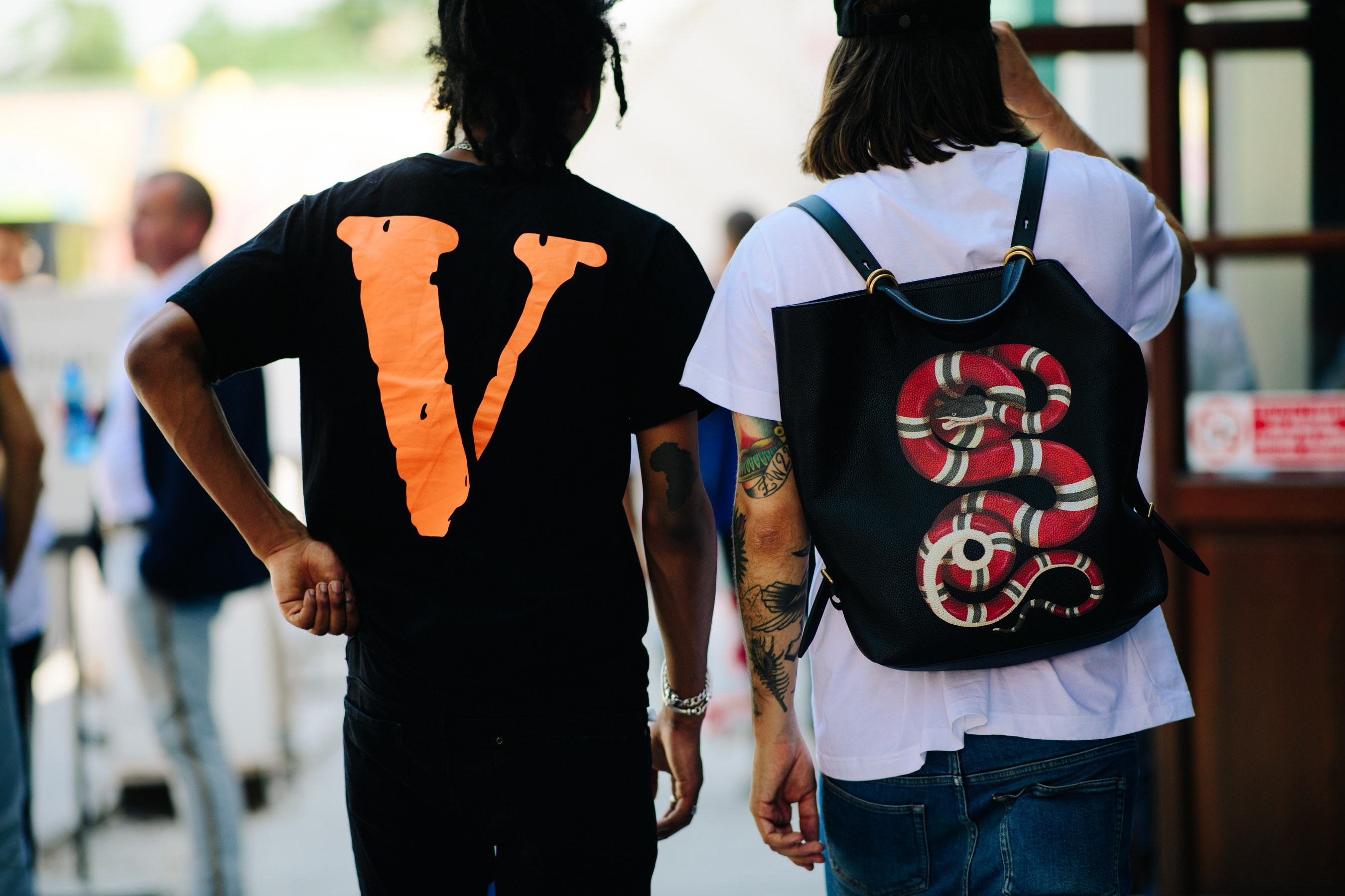 Two men wearing Vlone and Gucci