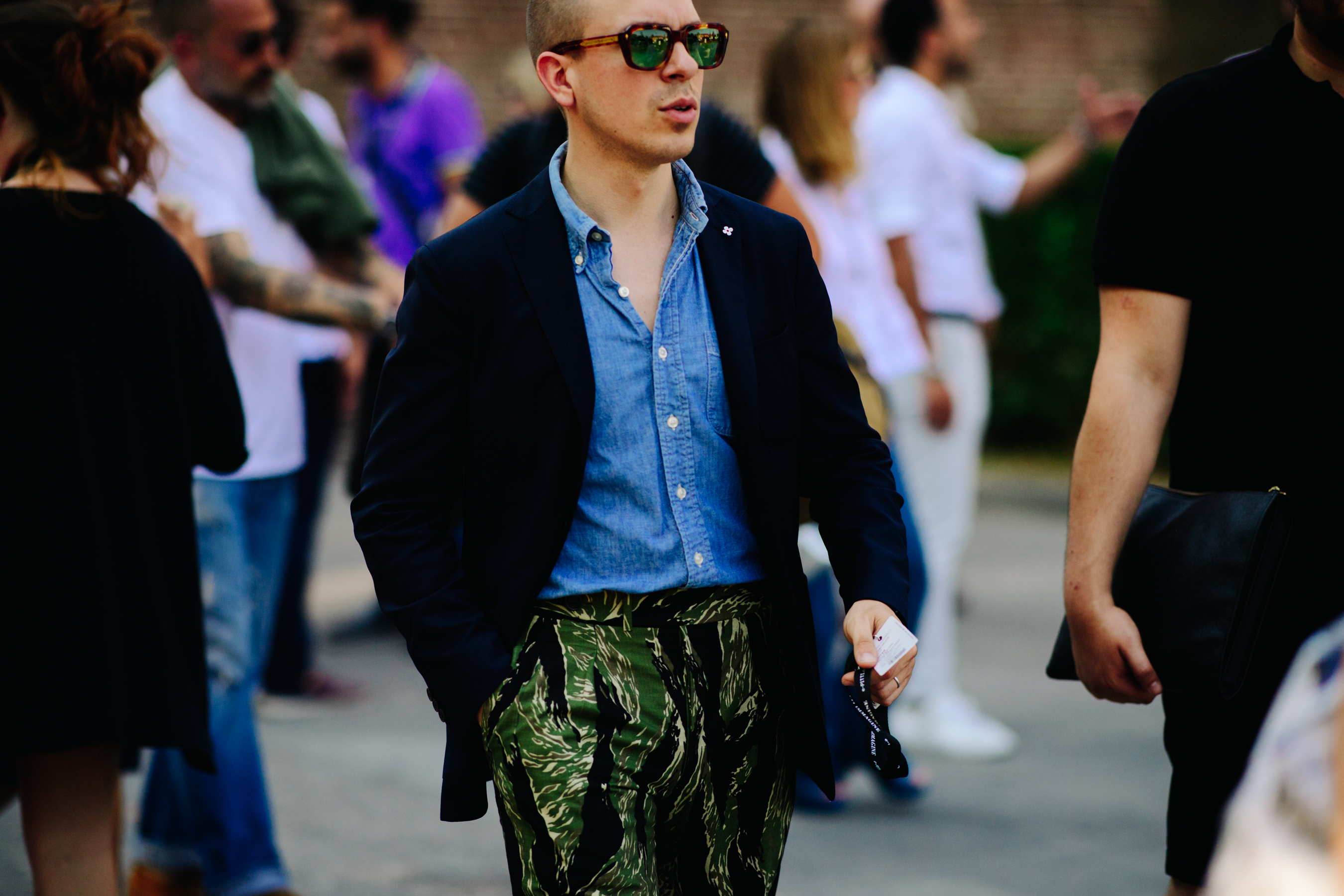 Man wearing denim shirt and camo pants