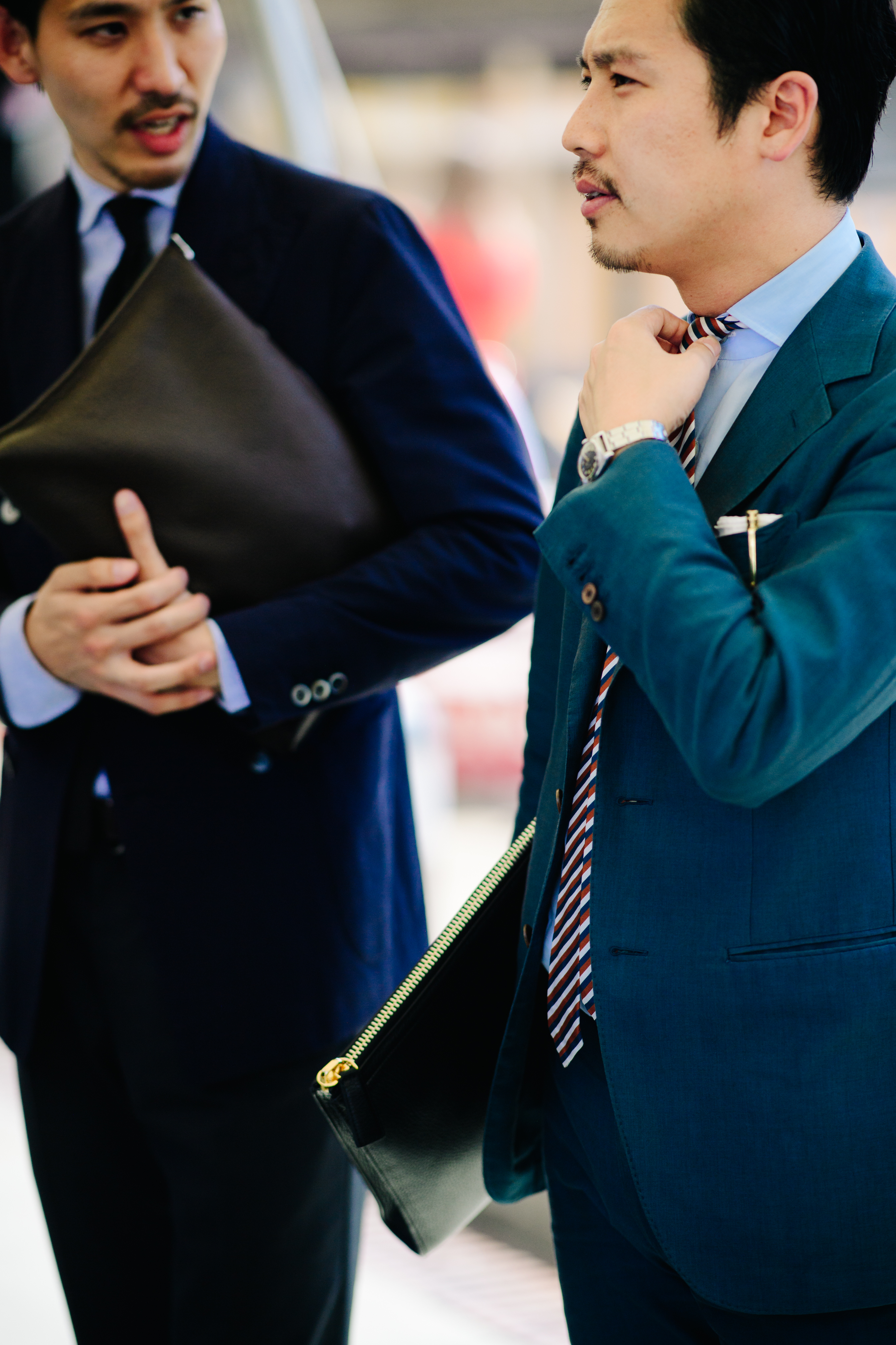 Two men wearing dark suits