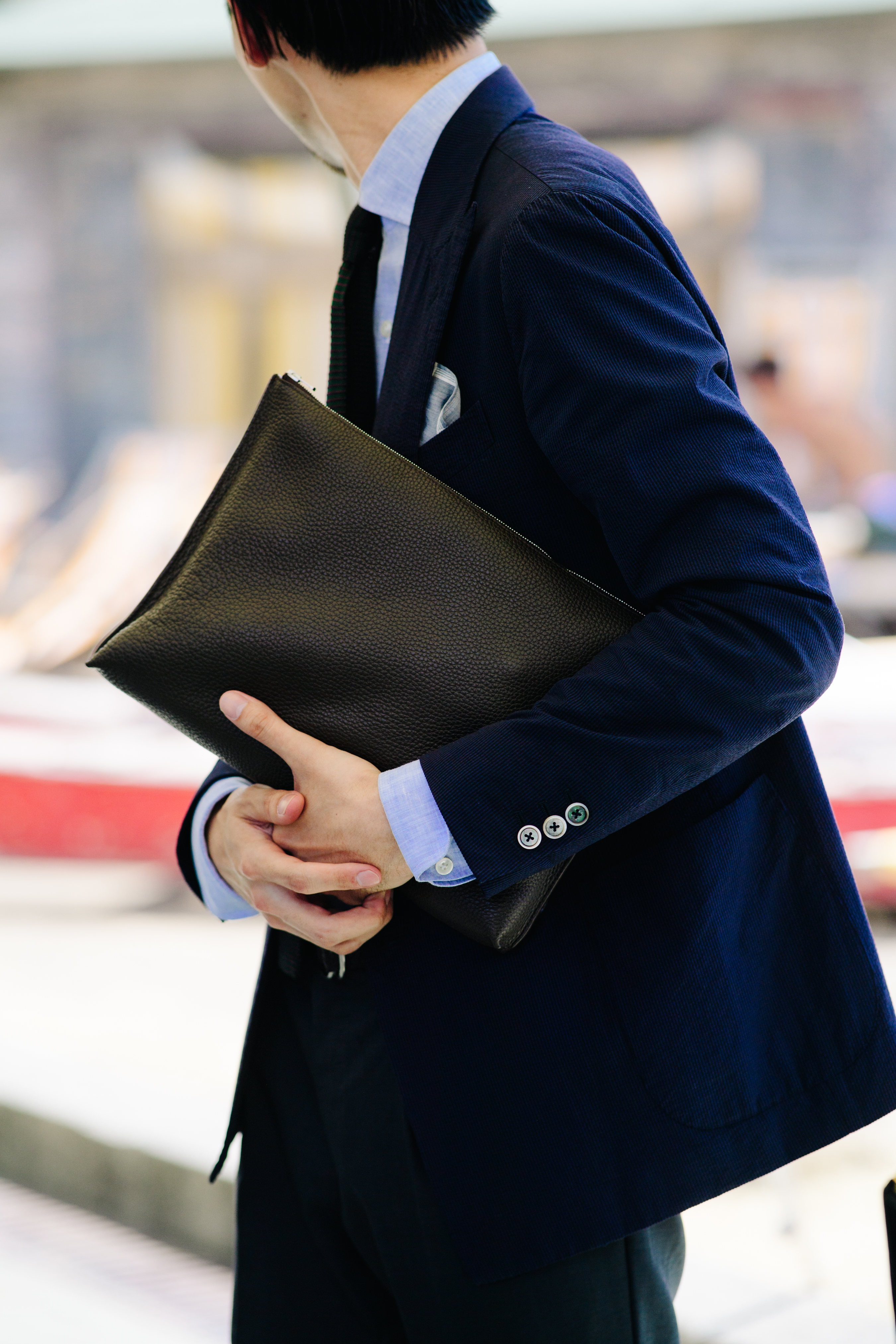Man carrying a leather clutch