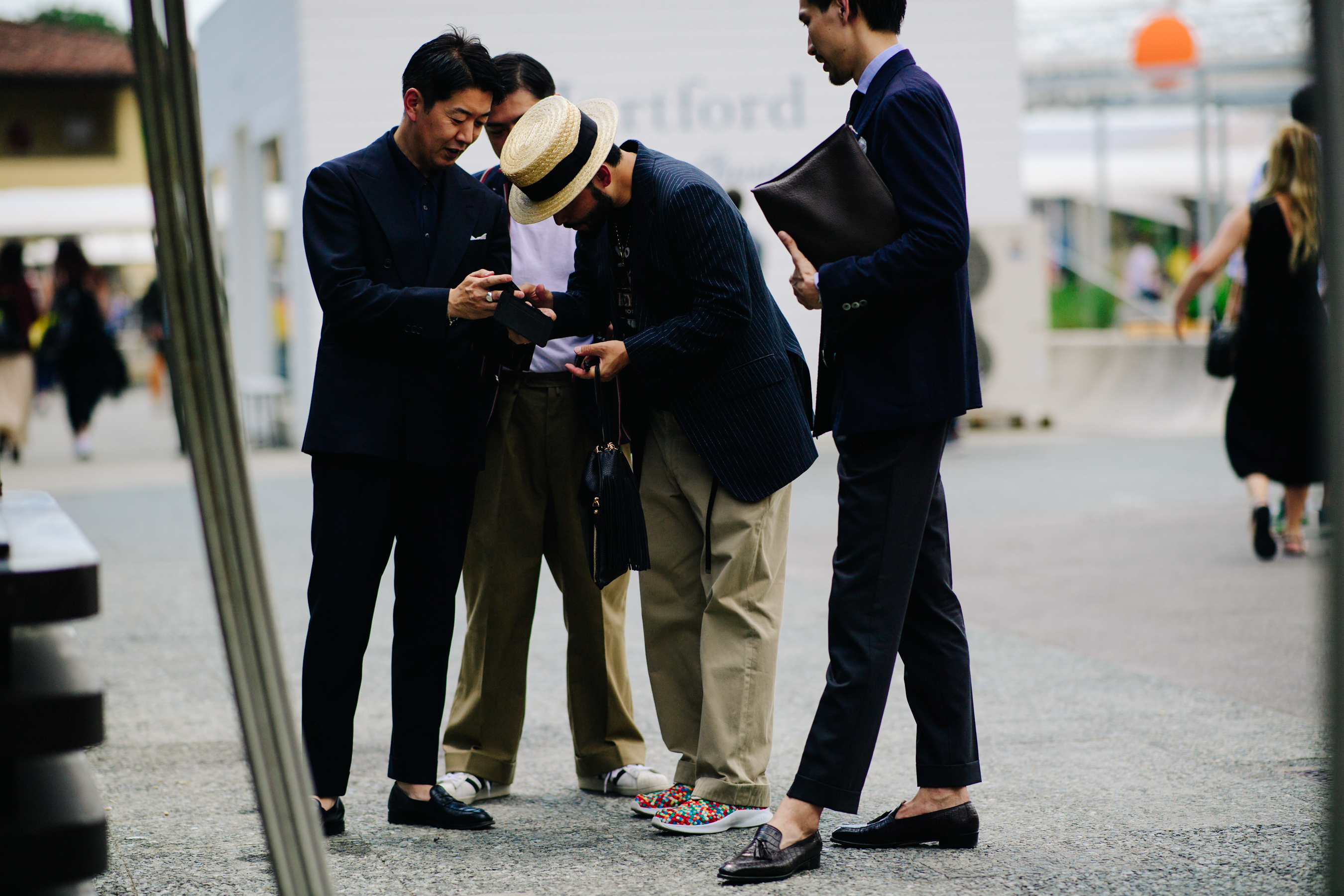 Four Asian men discussing on the street