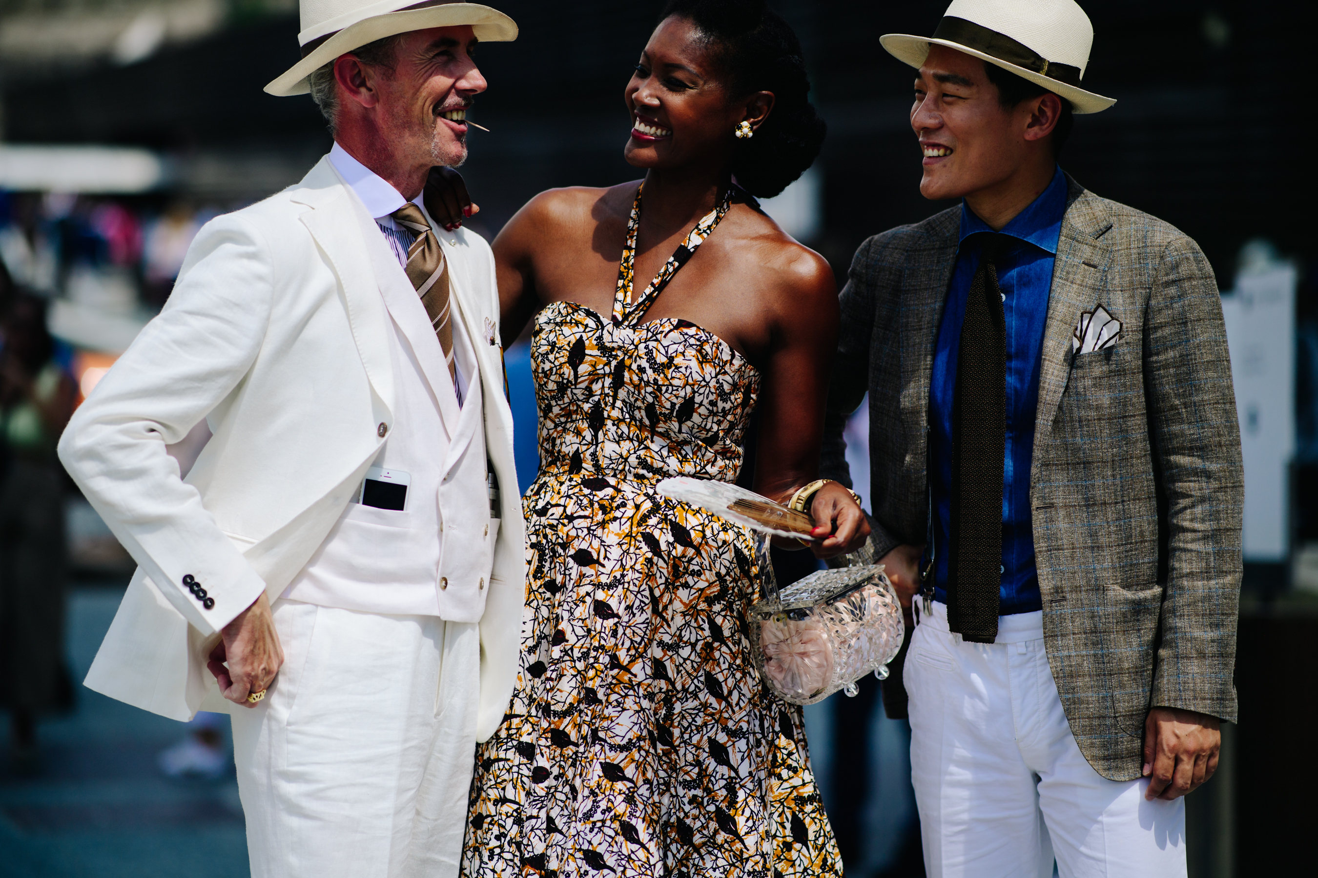 A woman and two men laughing
